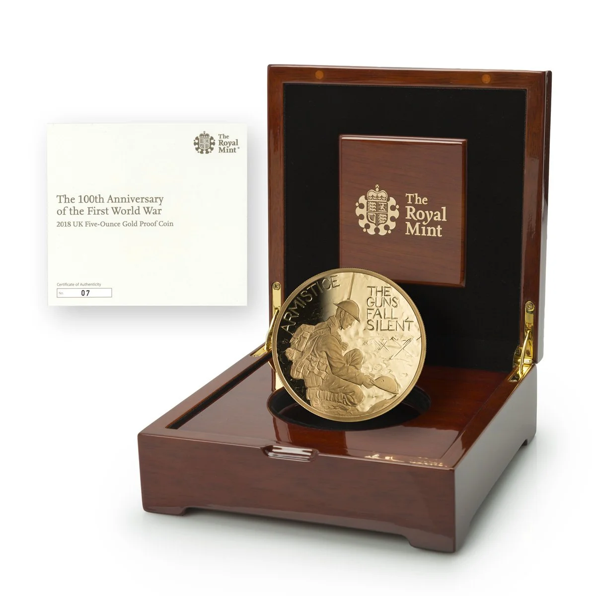 Gold proof coin commemorating the 100th anniversary of the First World War, featuring a soldier and the text "War is the only justice", in a wooden display case with a certificate of authenticity.