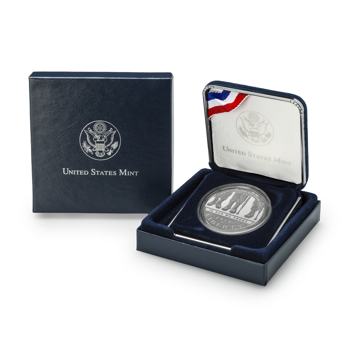 A silver coin with the word 'LIBERTY' and the year 2006 engraved on it, inside a navy blue velvet-lined case with an American flag ribbon. The case is open, and a box with the United States Mint logo is nearby.