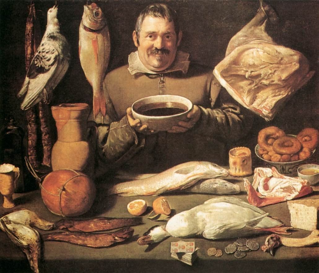 Kitchen scene of Bodegón. The laughing kitchen chef holding a large bowl of red wine in his hands stands behind a table on which all sorts of food is laid out. In the front a pack of cards and some loose change is shown. Artist unknown- Between 1610 