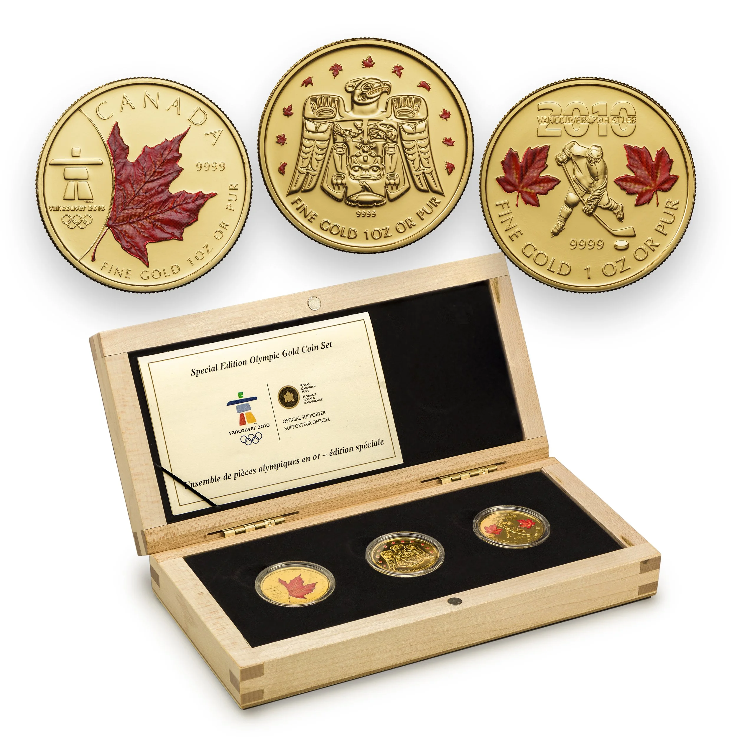 2010 Vancouver Olympics special edition gold coin set with three 1 oz gold coins featuring Canadian symbols in a wooden display box.