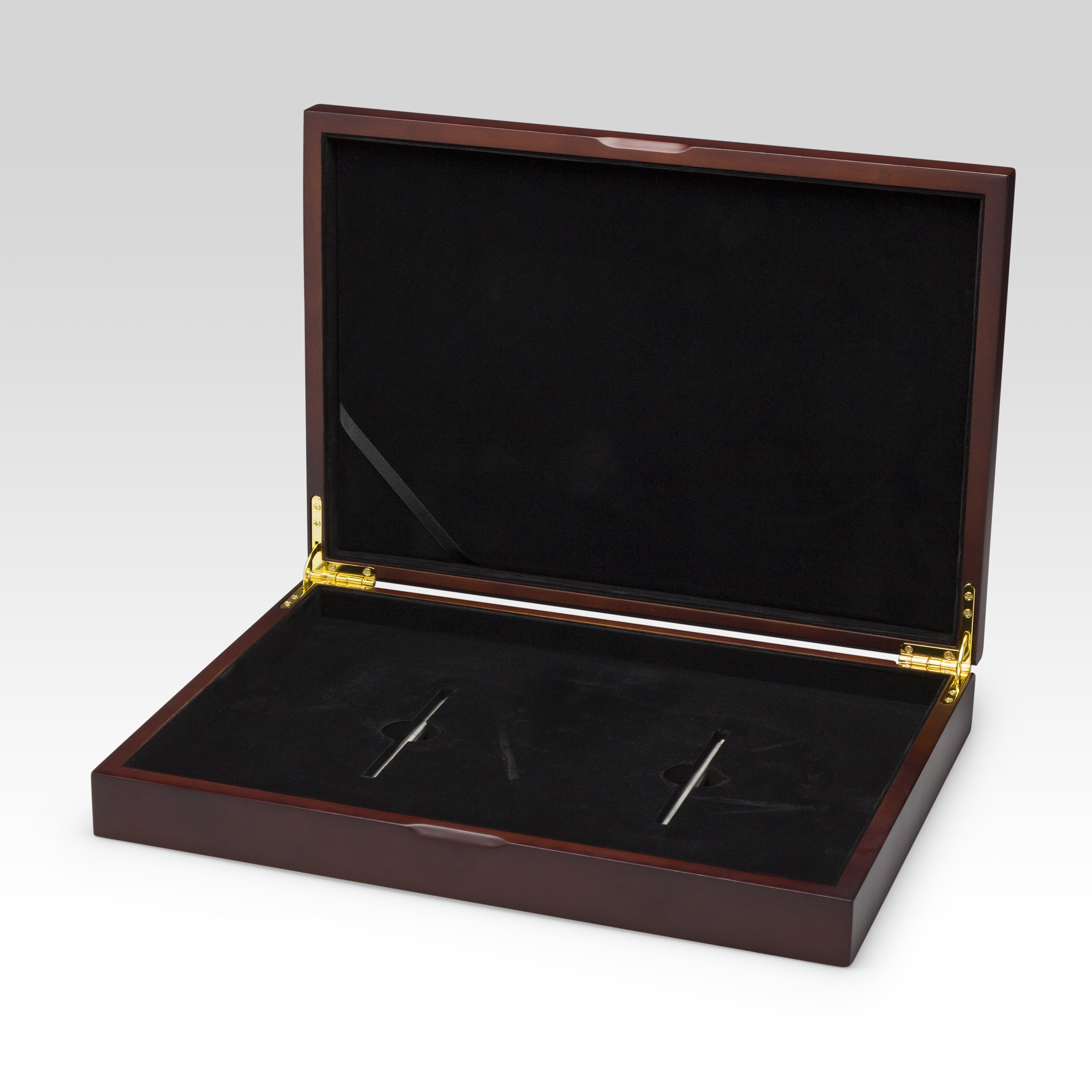 An empty wooden presentation box with a black velvet interior and gold hinges, designed for holding and displaying two pens.