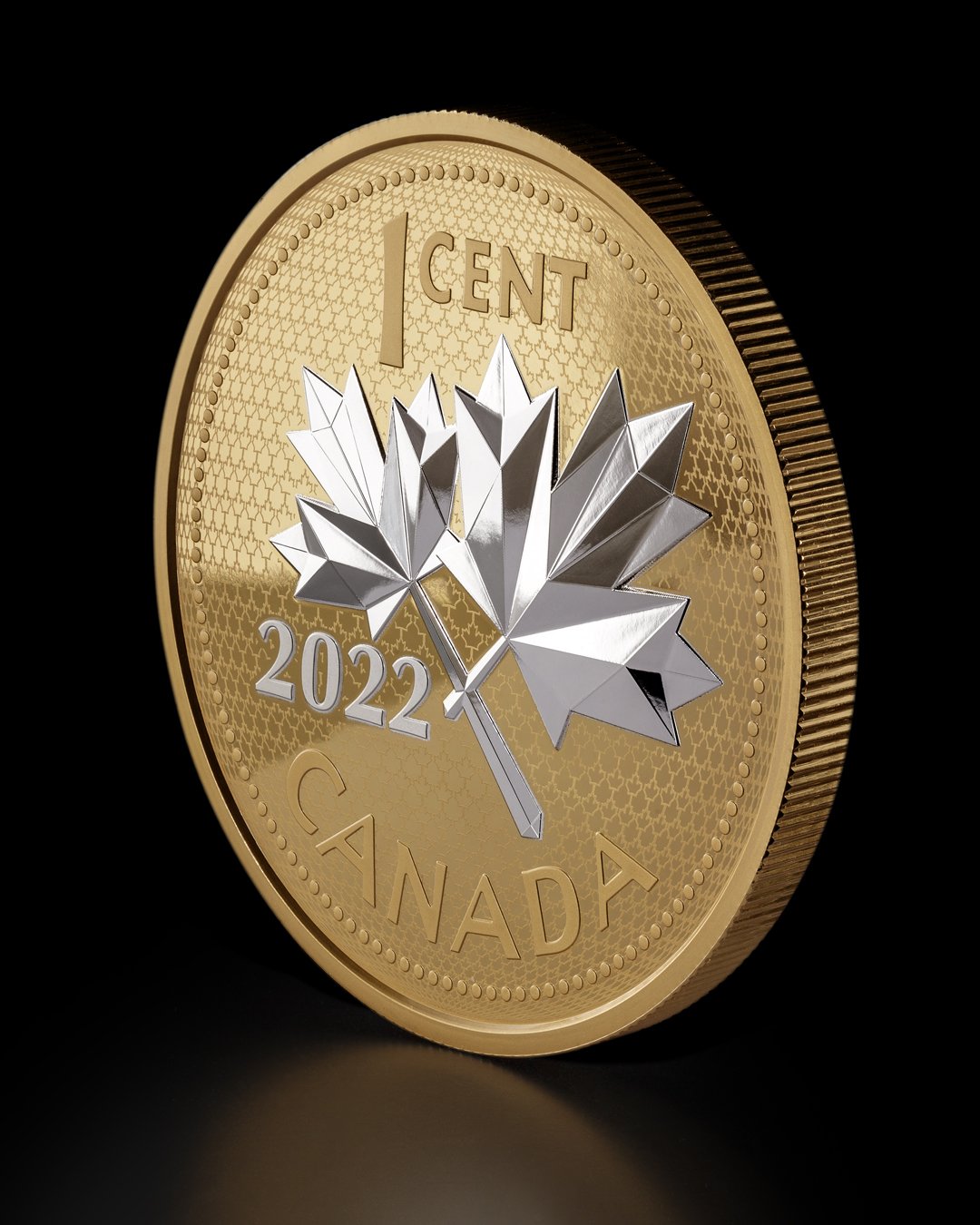 A 2022 Canadian one-cent coin with a silver maple leaf in the center against a black background.