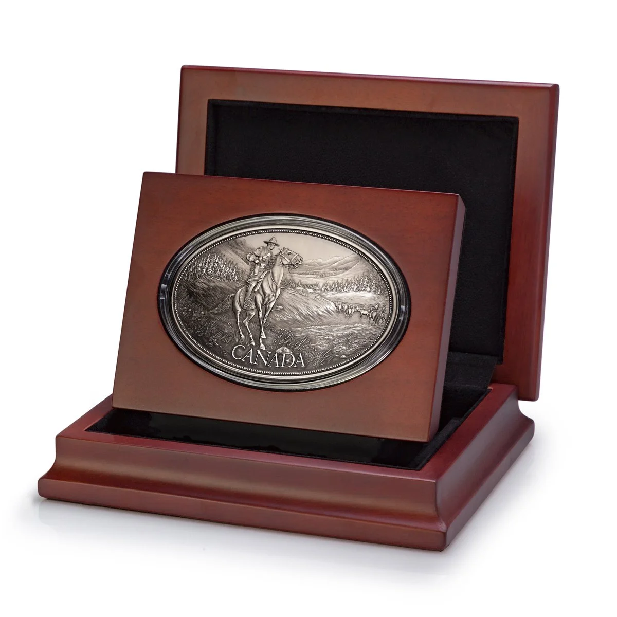 Wooden presentation box with a metal plaque depicting a mounted Royal Canadian Mounted Police officer, labeled "Canada."