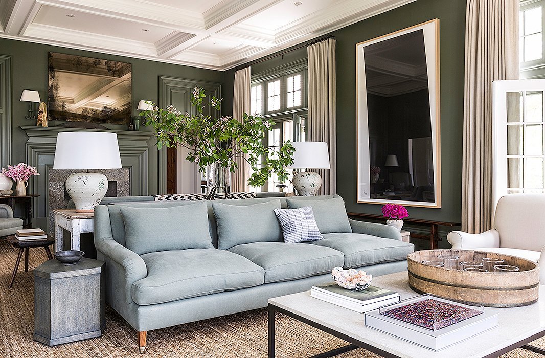  This beautiful sofa provides the icey blue in this Connecticut living room. The olive green walls and natural textures throughout, in particular the sisal rug and cream colored drapes, warm up the space, making it the perfect place to curl up with a