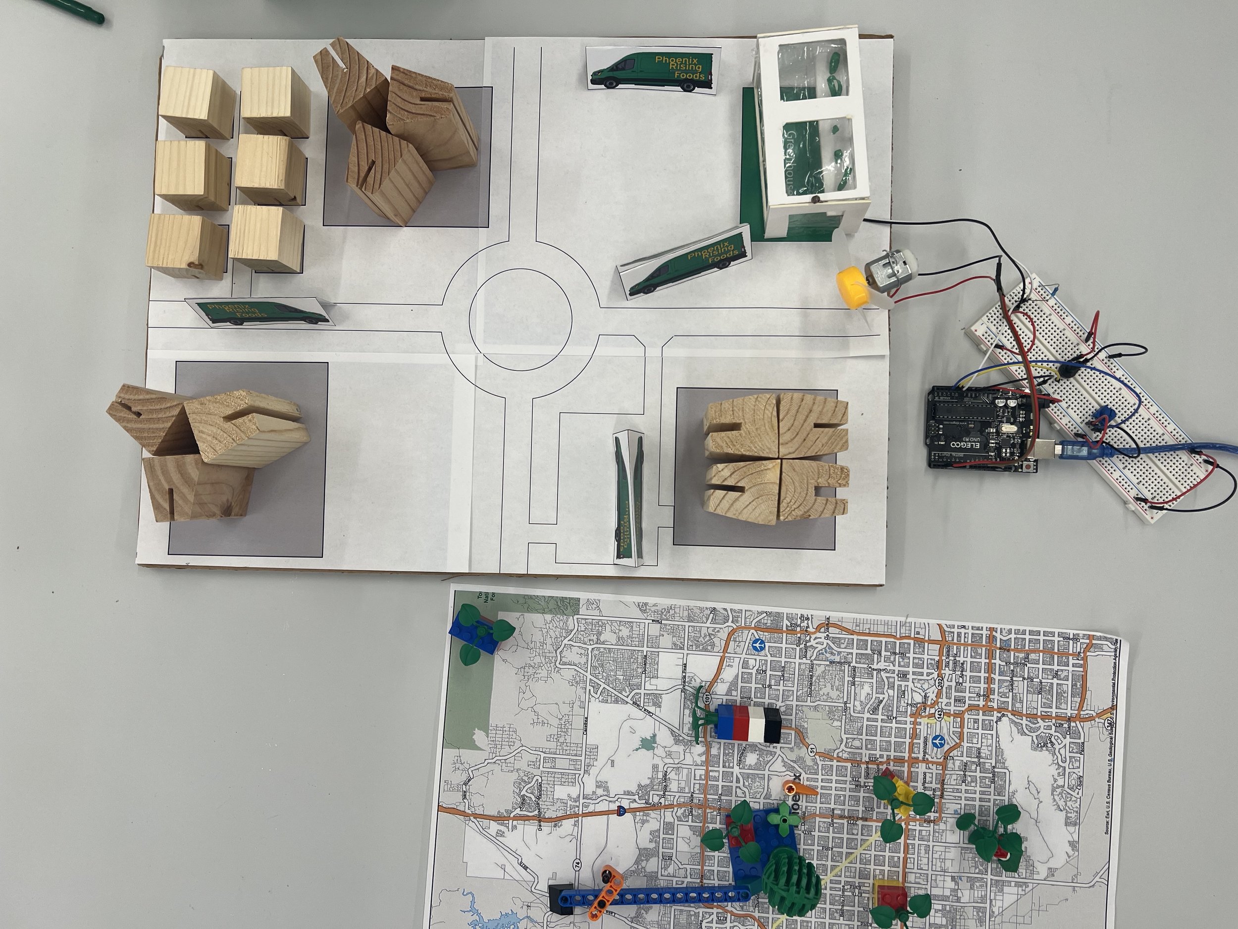 Our first physical prototype of a compost-for-food exchange service in Phoenix, Arizona. Note the arduino-powered sensing to optimize growing conditions, distributed network of greenhouses around the city and the compost-for-food exchange program.