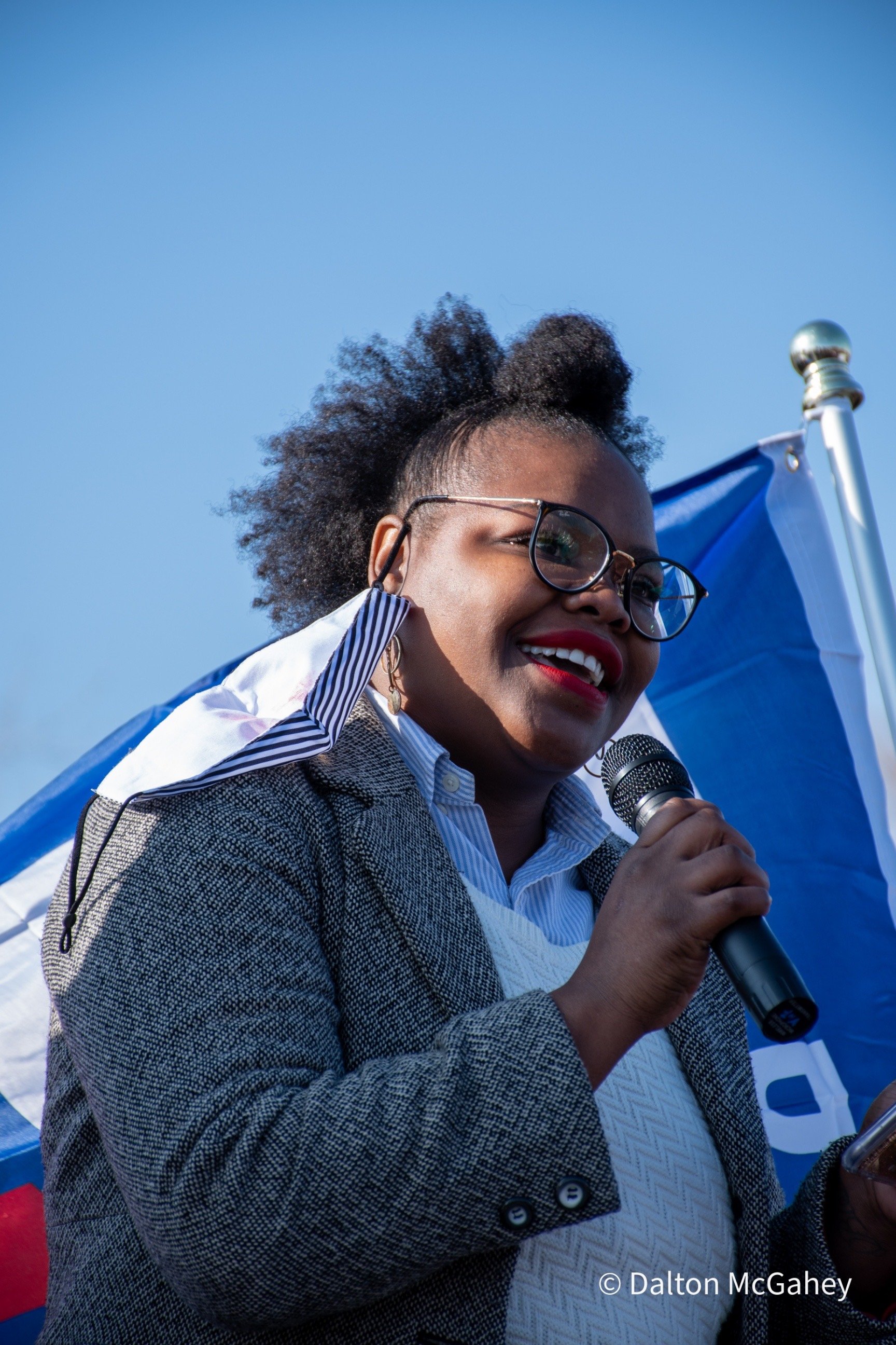 Shontel Lewis smiling and speaking into a mic