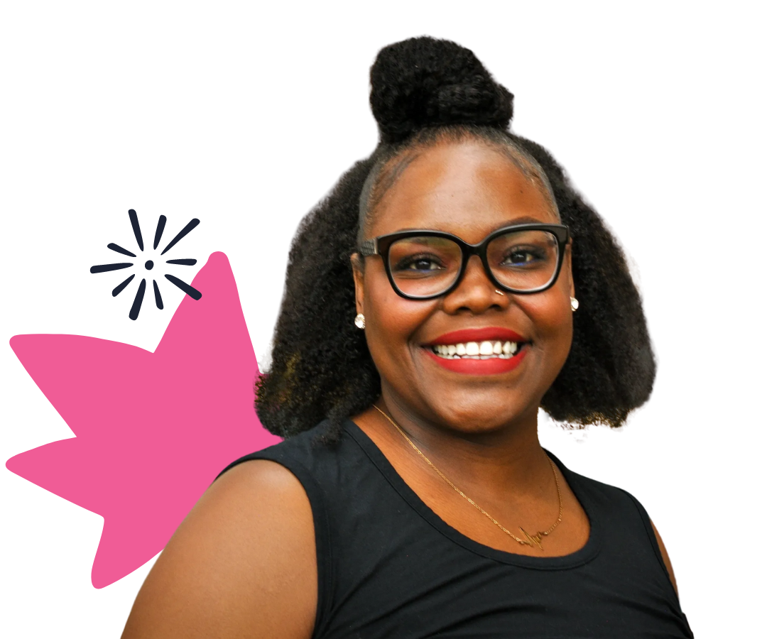 Shontel Lewis smiling with shoulder length dark hair, glasses, and her signature red lipstick.