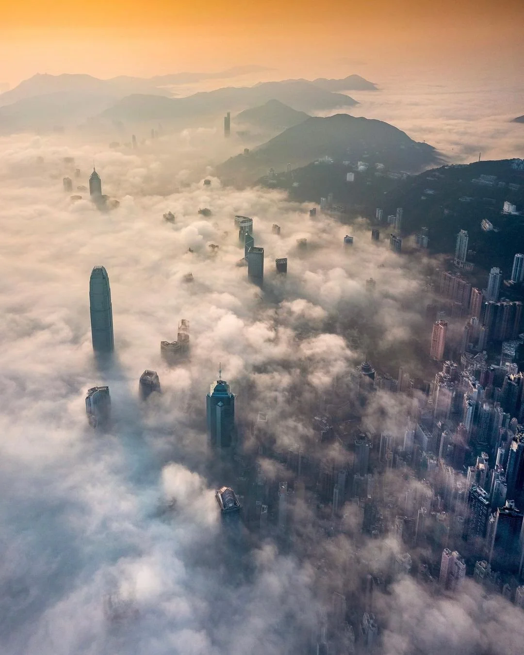 Aerial Image above Hong Kong at sunrise as low clouds sweep in