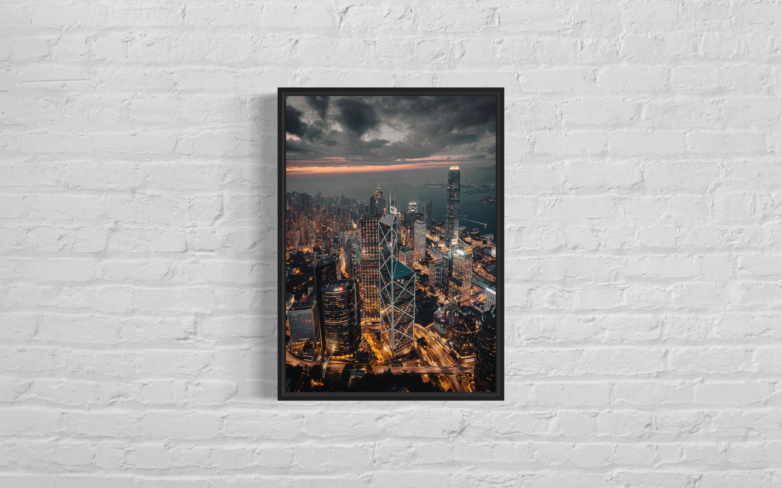 A framed artwork showcasing a high-quality photographic print of the Bank of China building lit up against the backdrop of a sunset in Admiralty, Hong Kong.