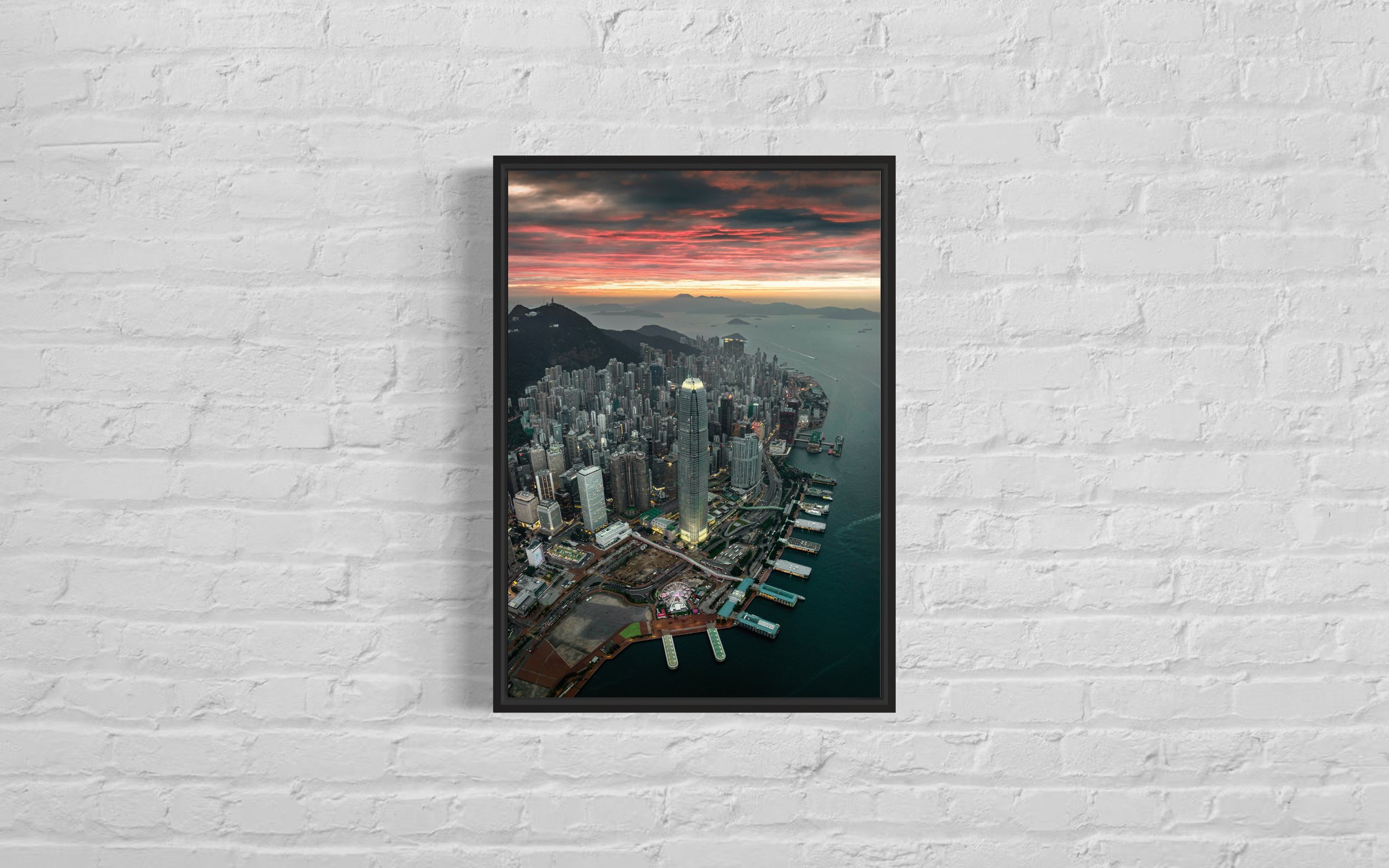 Framed aerial image of the International Finance Centre (IFC) building at sunset in Hong Kong.