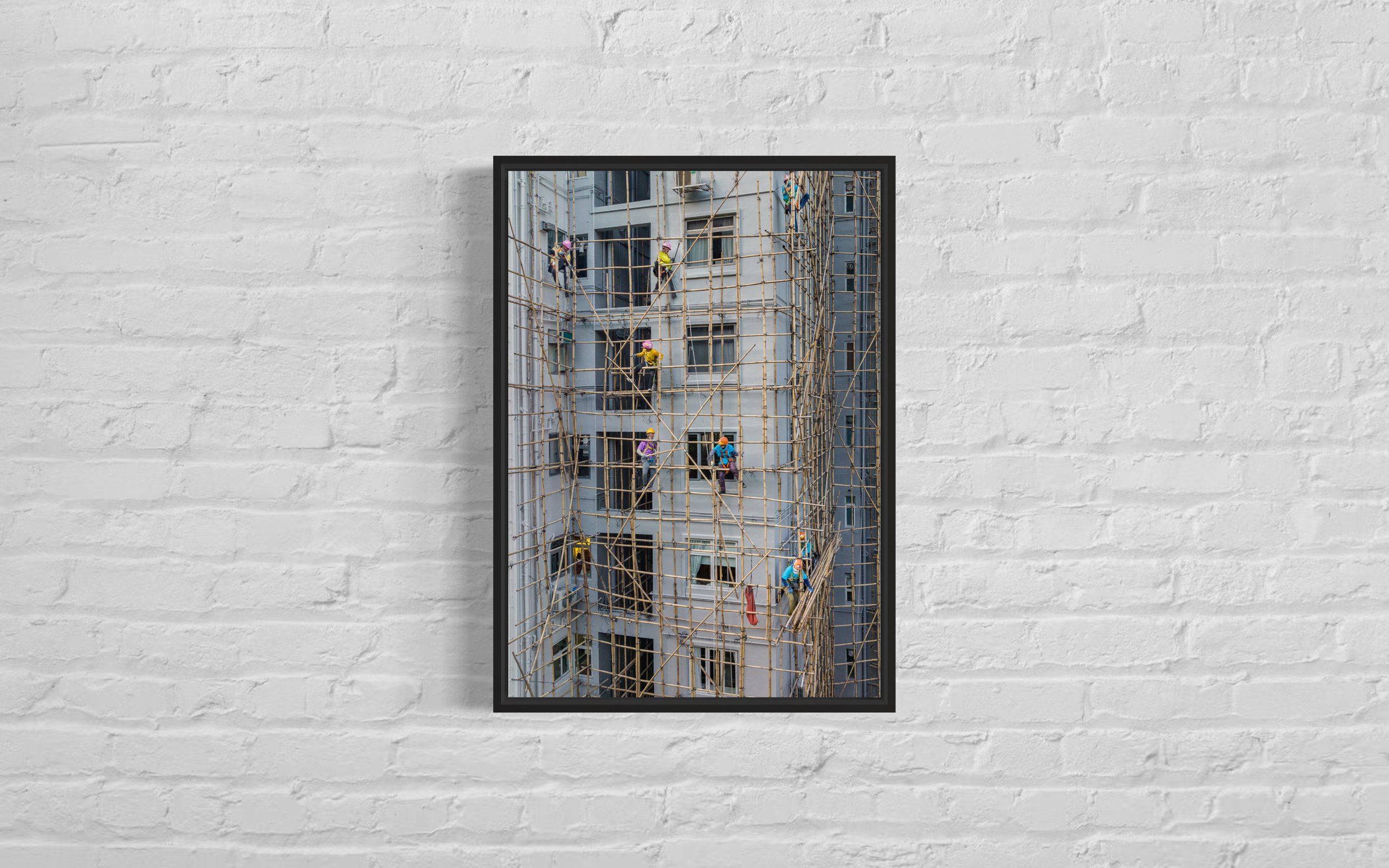 High-quality fine art photographic print showing construction workers on bamboo scaffolding on a tall building in Hong Kong.