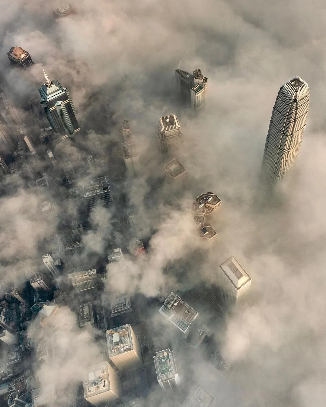 IFC and CBD of Hong Kong surrounded by low clouds at sunrise