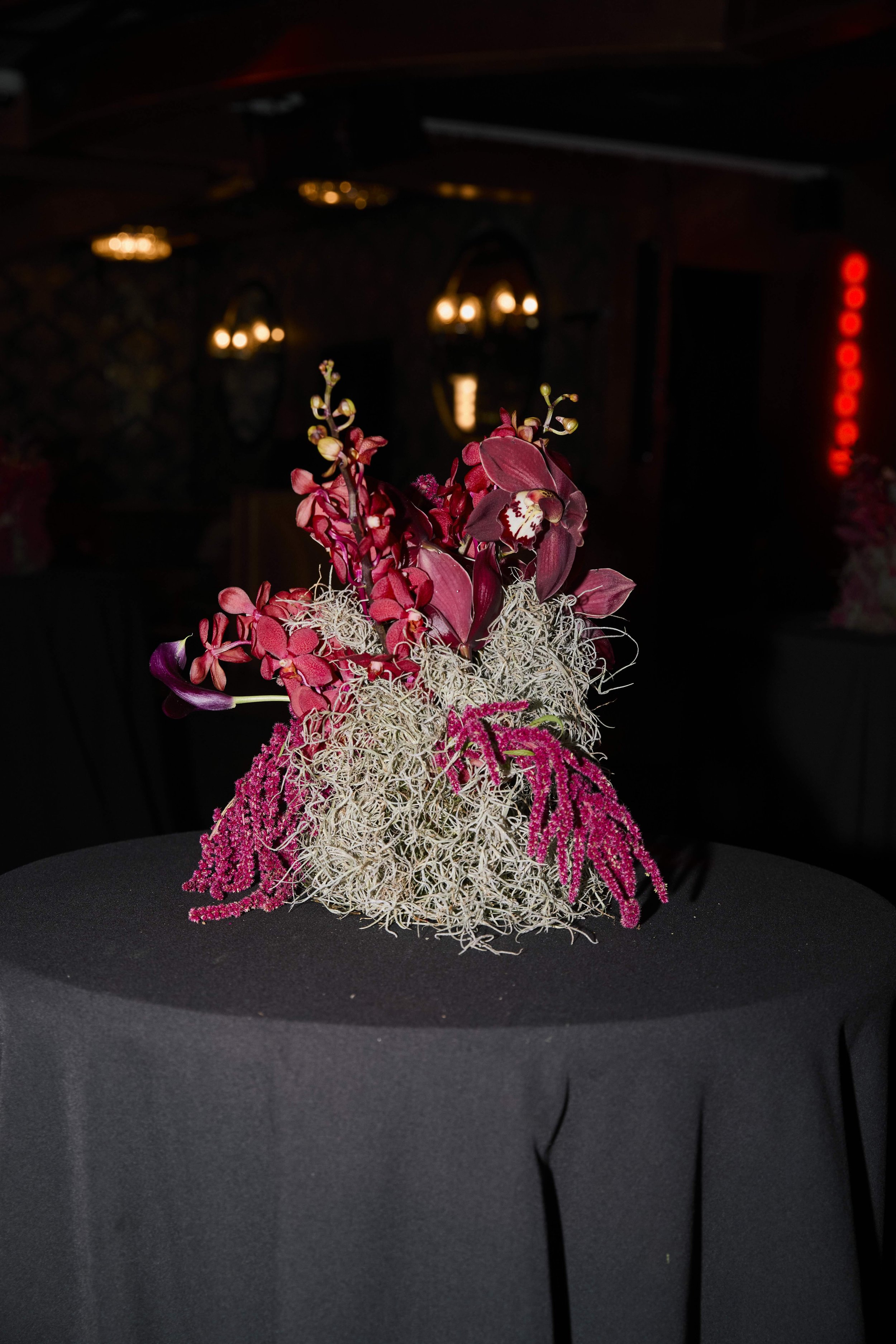 Sculptural floral centerpiece at an upscale celebrity event.