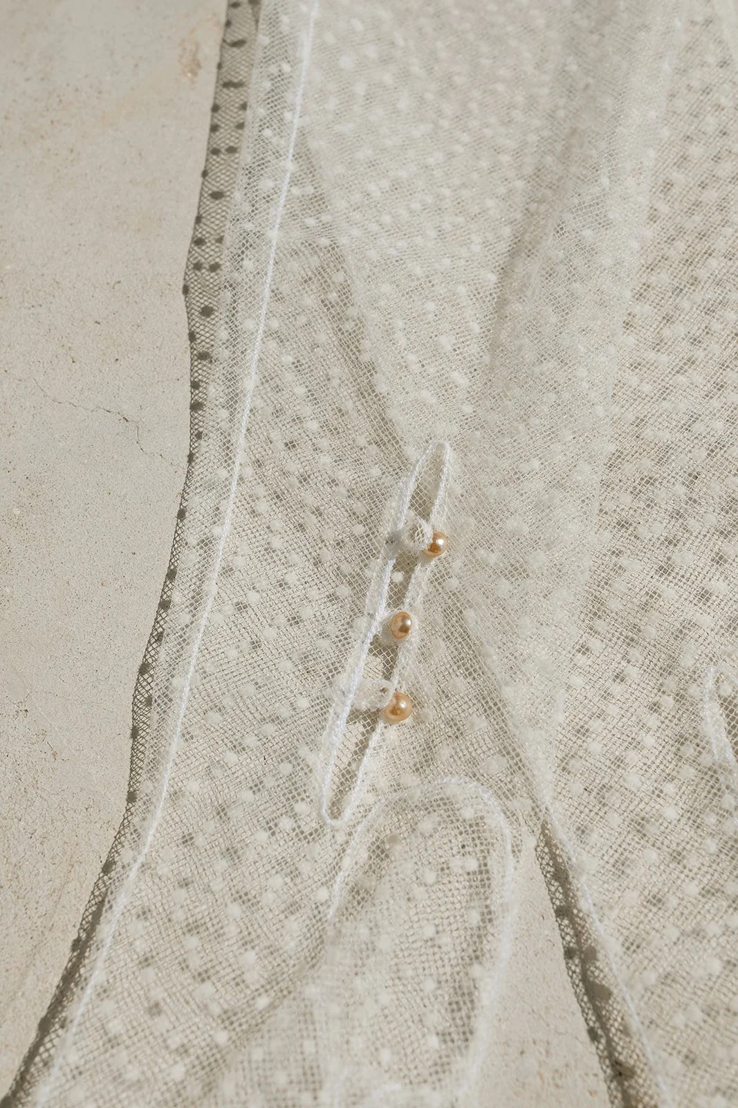 Wedding dress detail with minimalist desert styling.