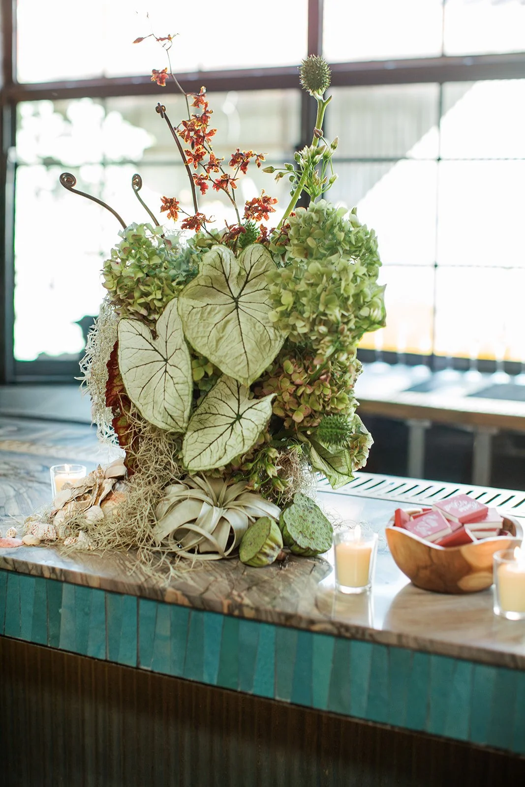 Elevated floral centerpiece at a Los Angeles restaurant wedding.