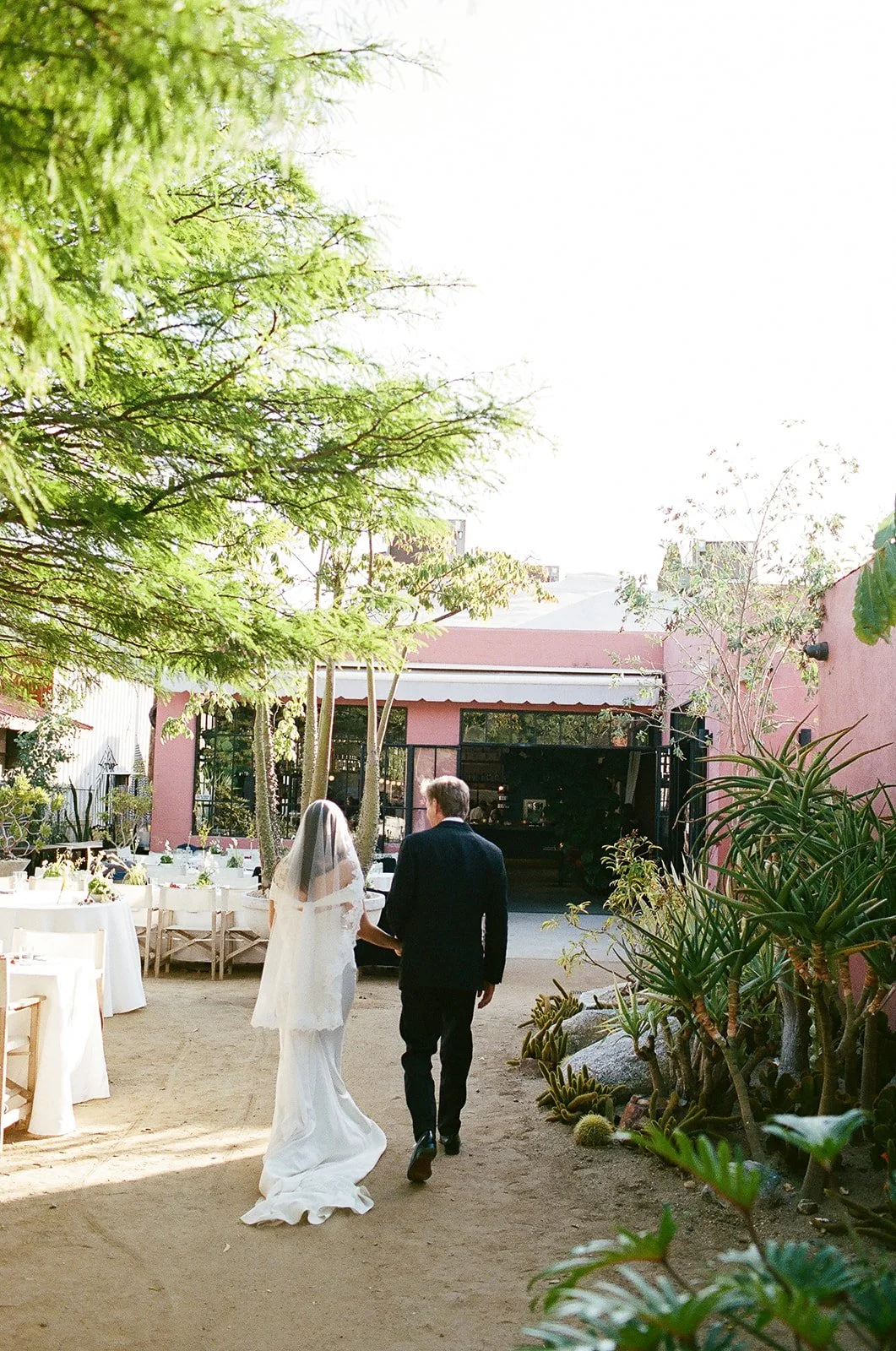Bride walking through outdoor Los Angeles wedding venue. 