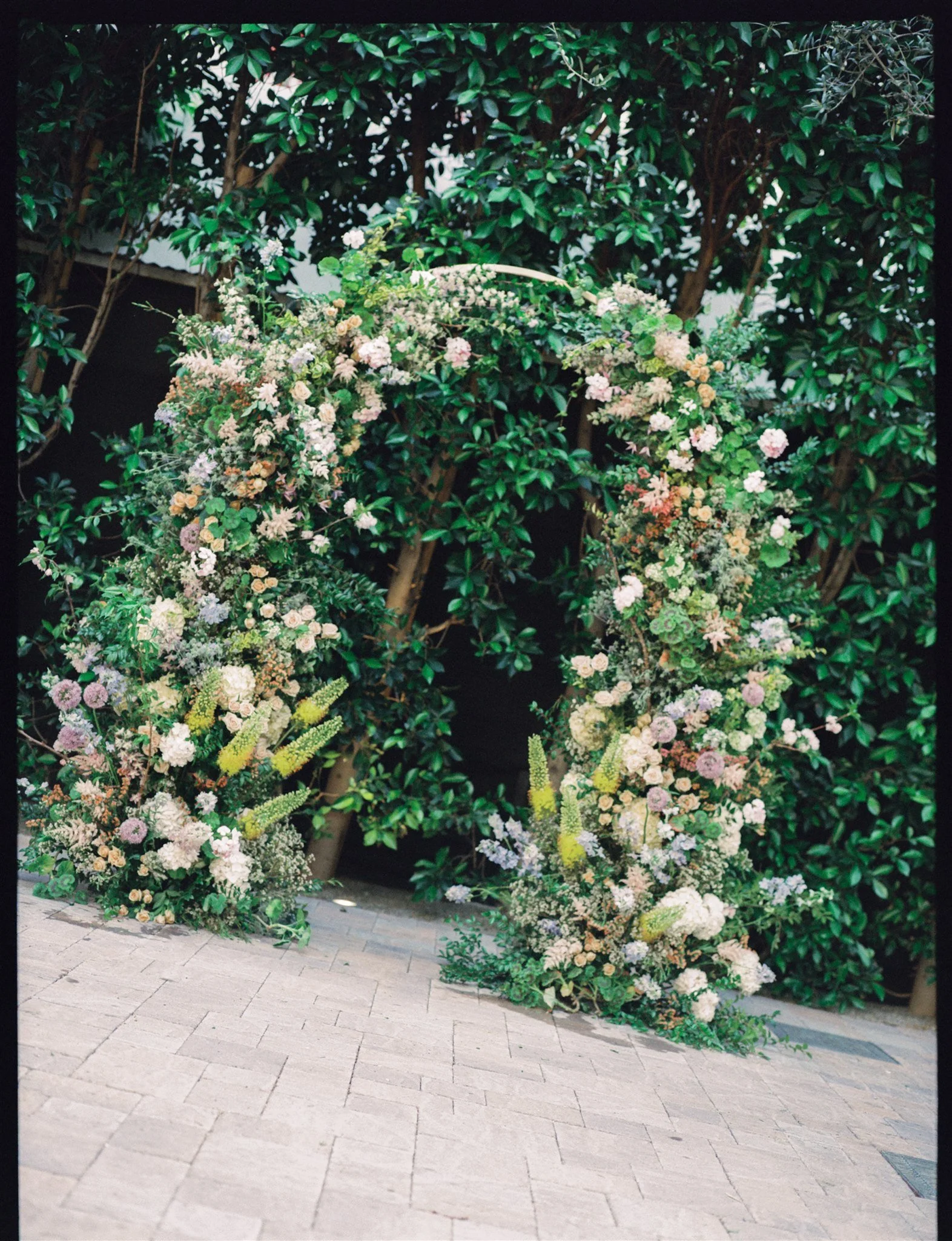 Floral ceremony arch at a Southern California restaurant wedding.