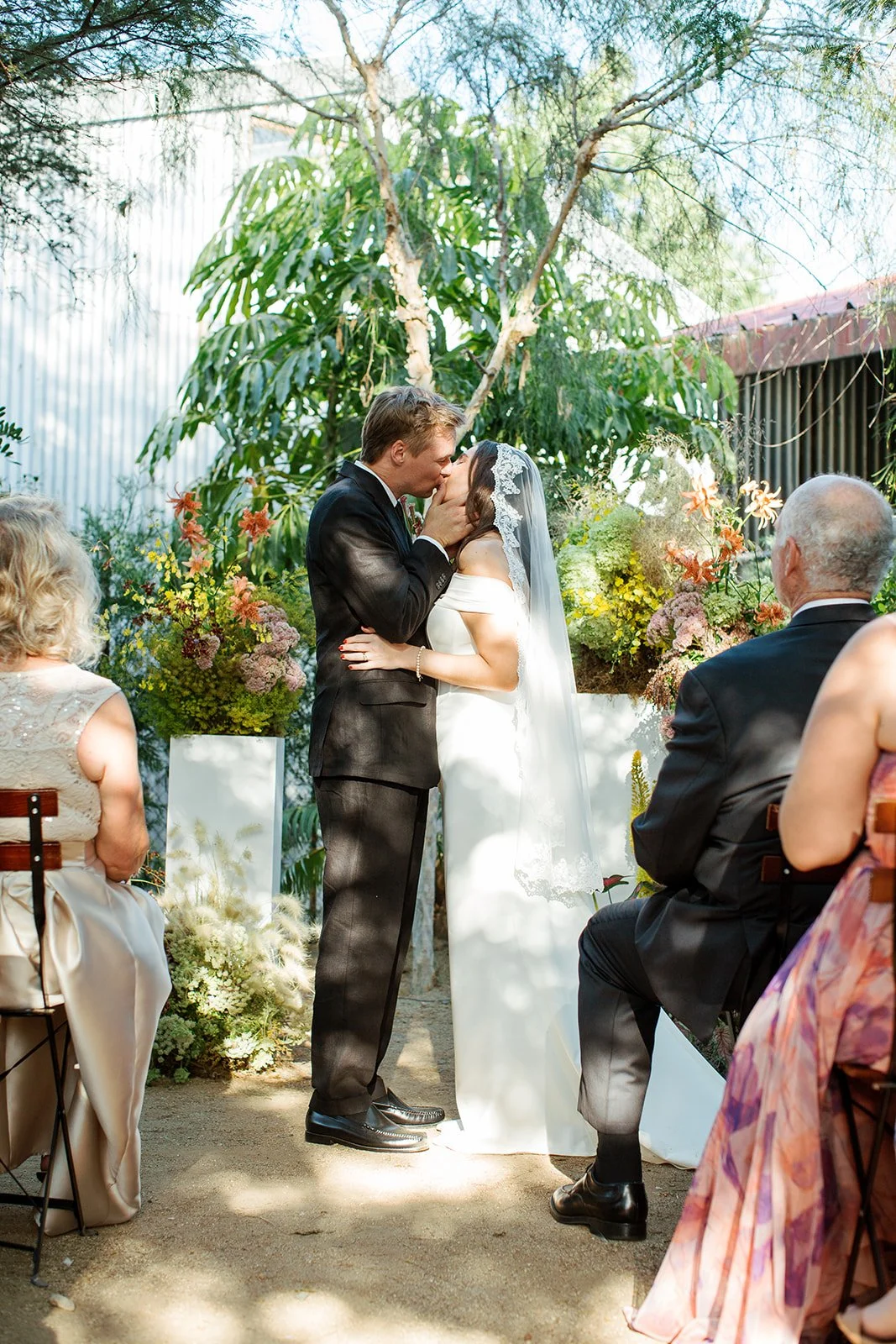First kiss at a Los Angeles restaurant wedding reception.