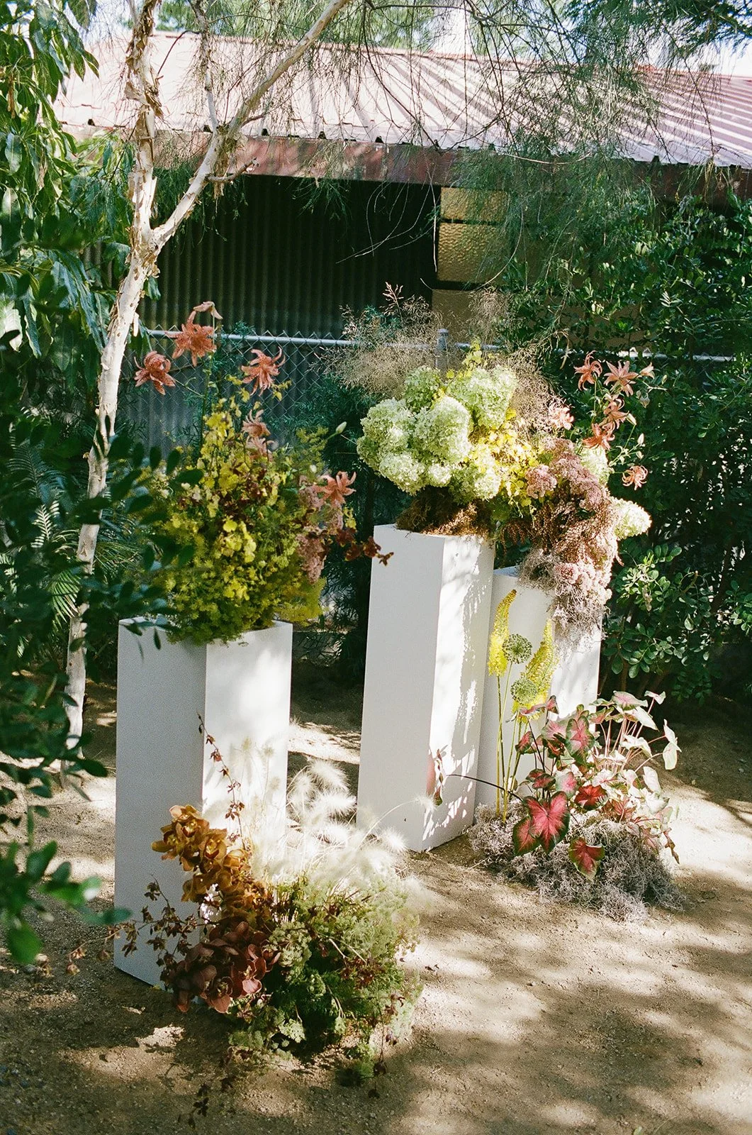 Sculptural floral arrangements at reception designed by Los Angeles wedding planner. 