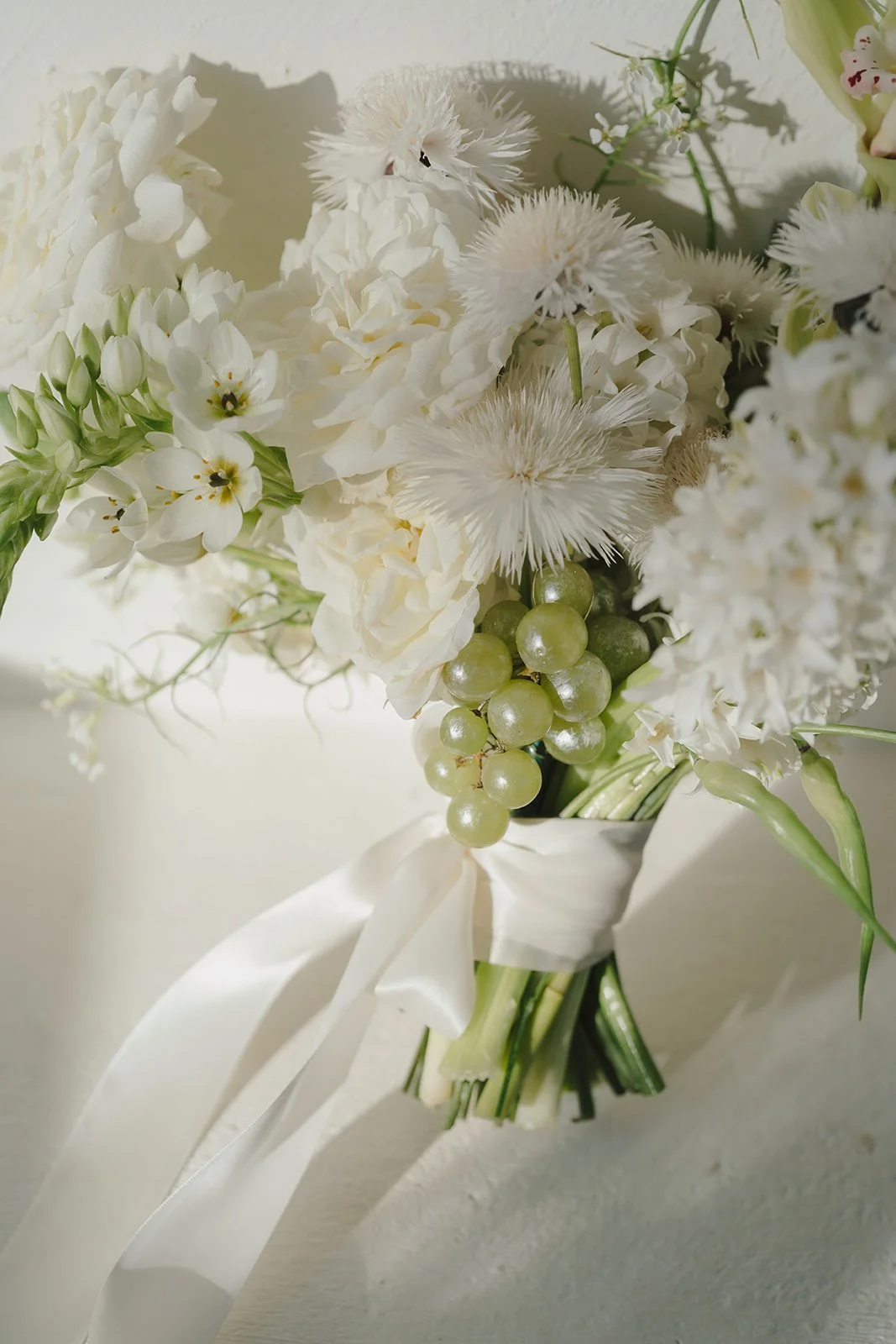 White bridal bouquet with textured florals at a California wedding.