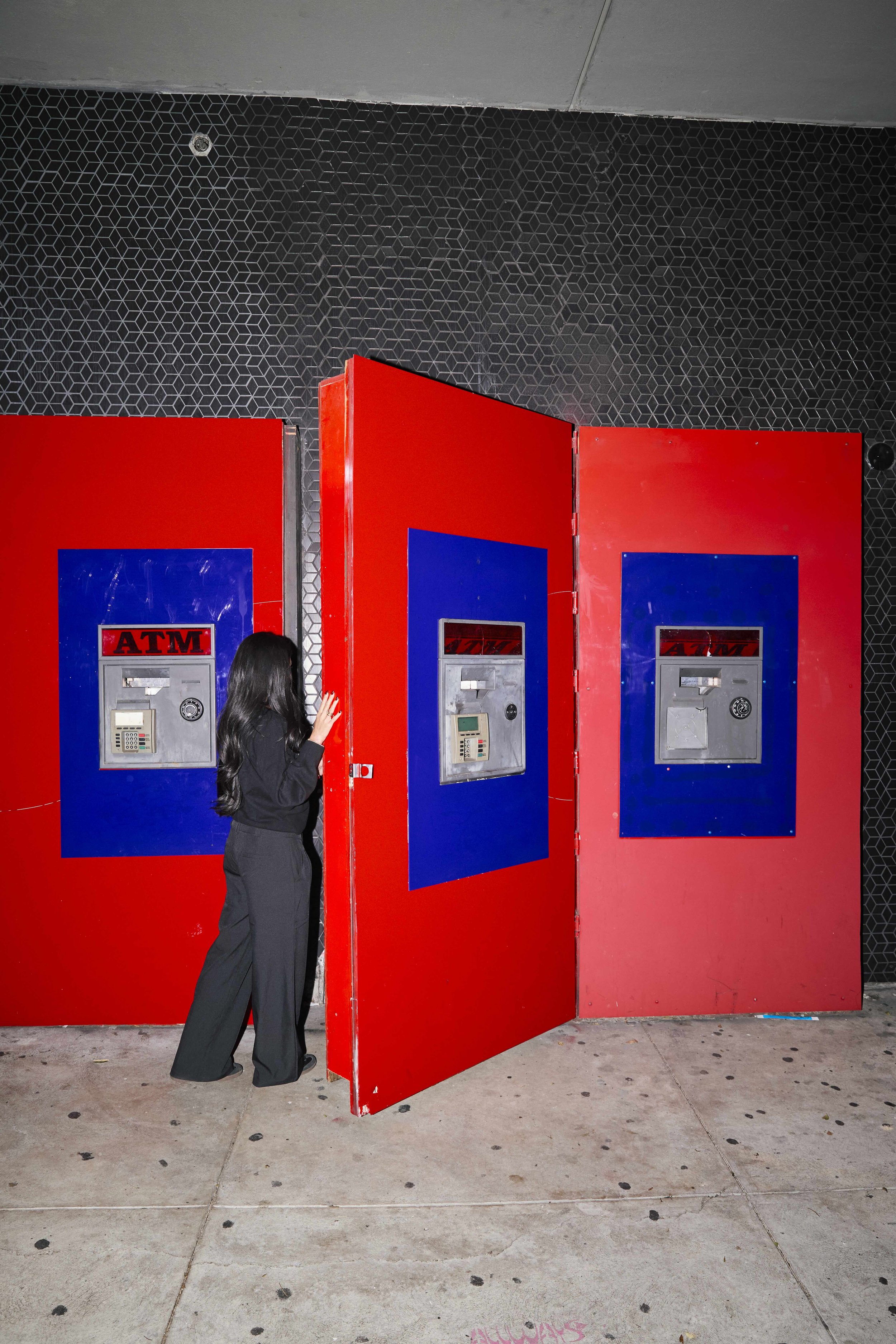 Immersive branded event experience with bold red architectural panels.