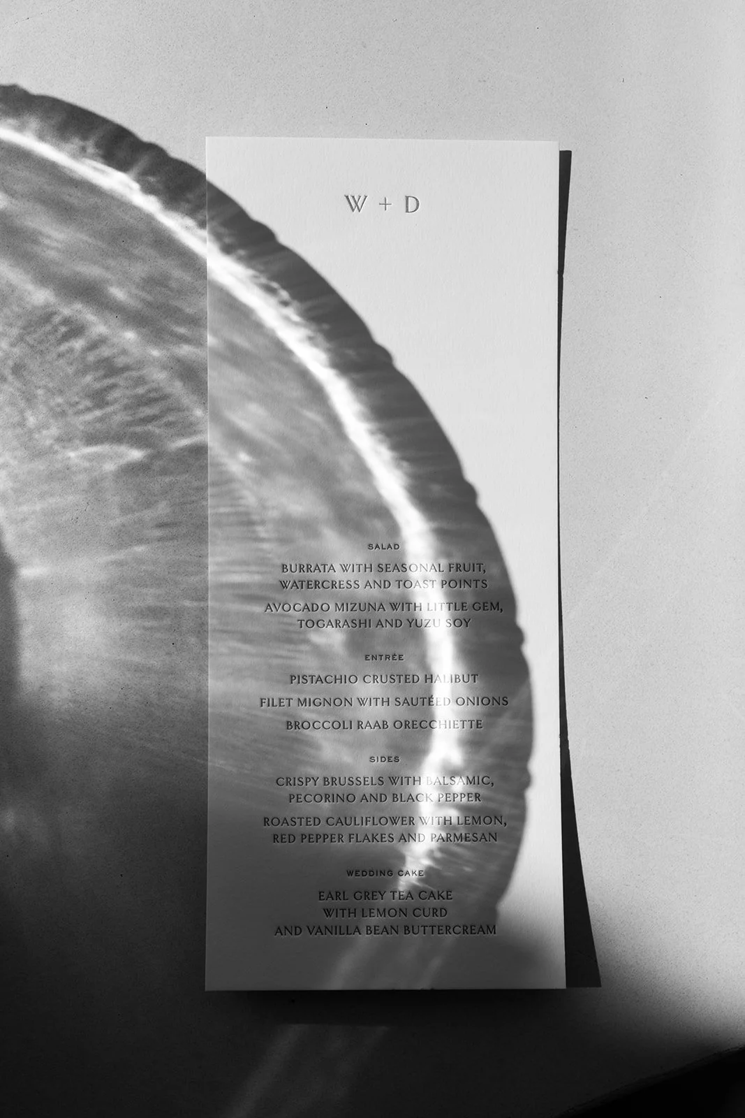 Wedding invitation suite styled against desert textures at a Joshua Tree wedding.