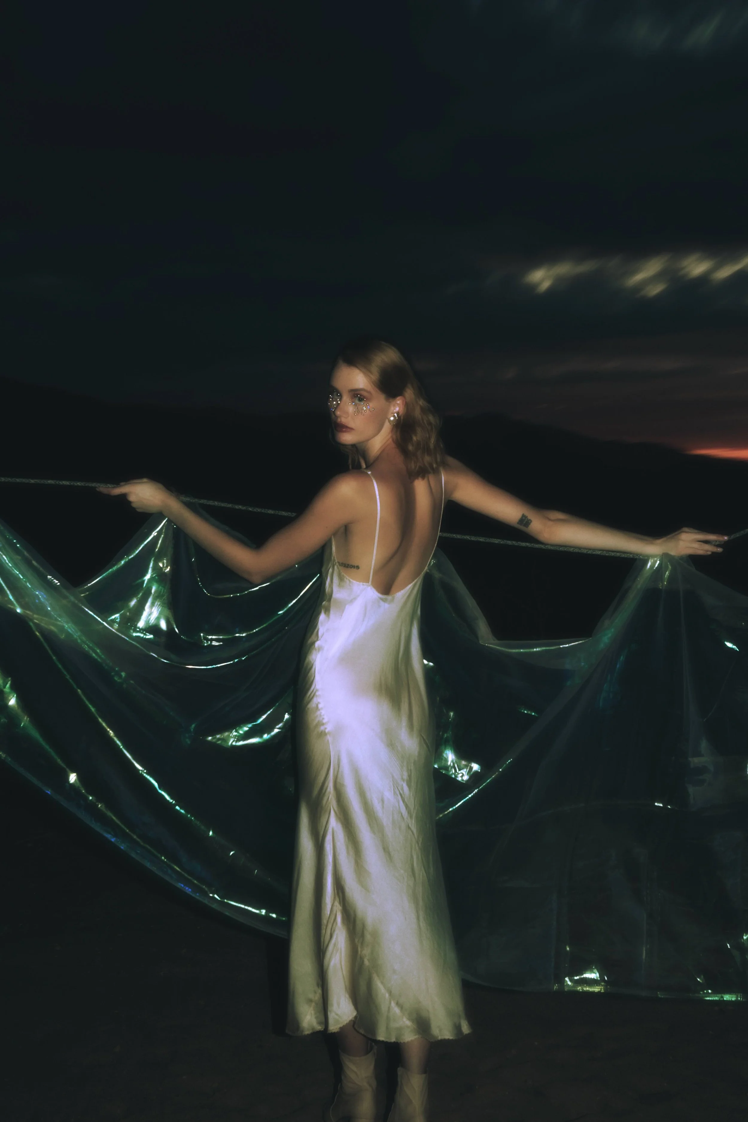 Bride at a Southern California desert wedding at sunset with mountain silhouettes