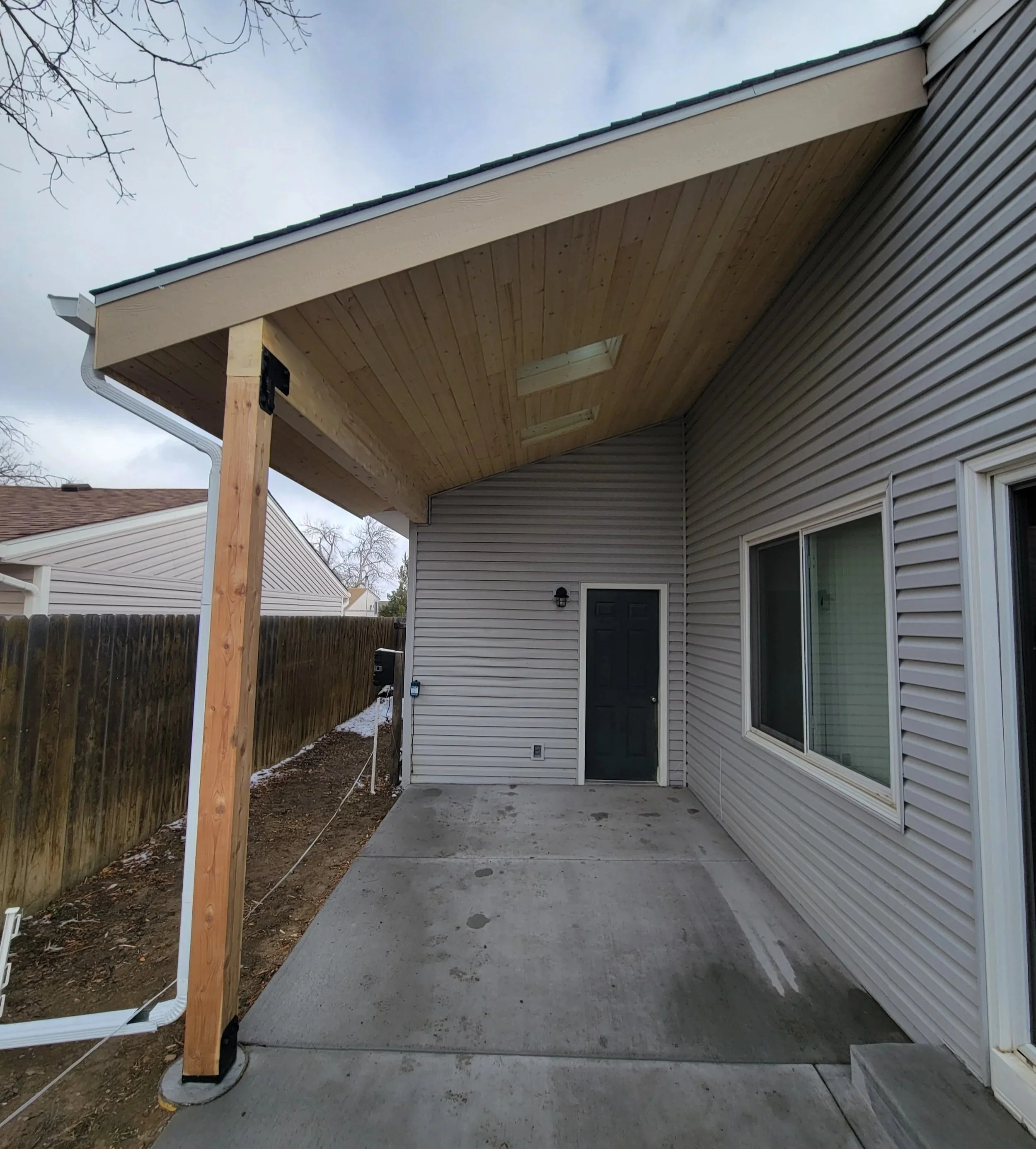 New patio cover with skylights, gutter, and pine ceiling