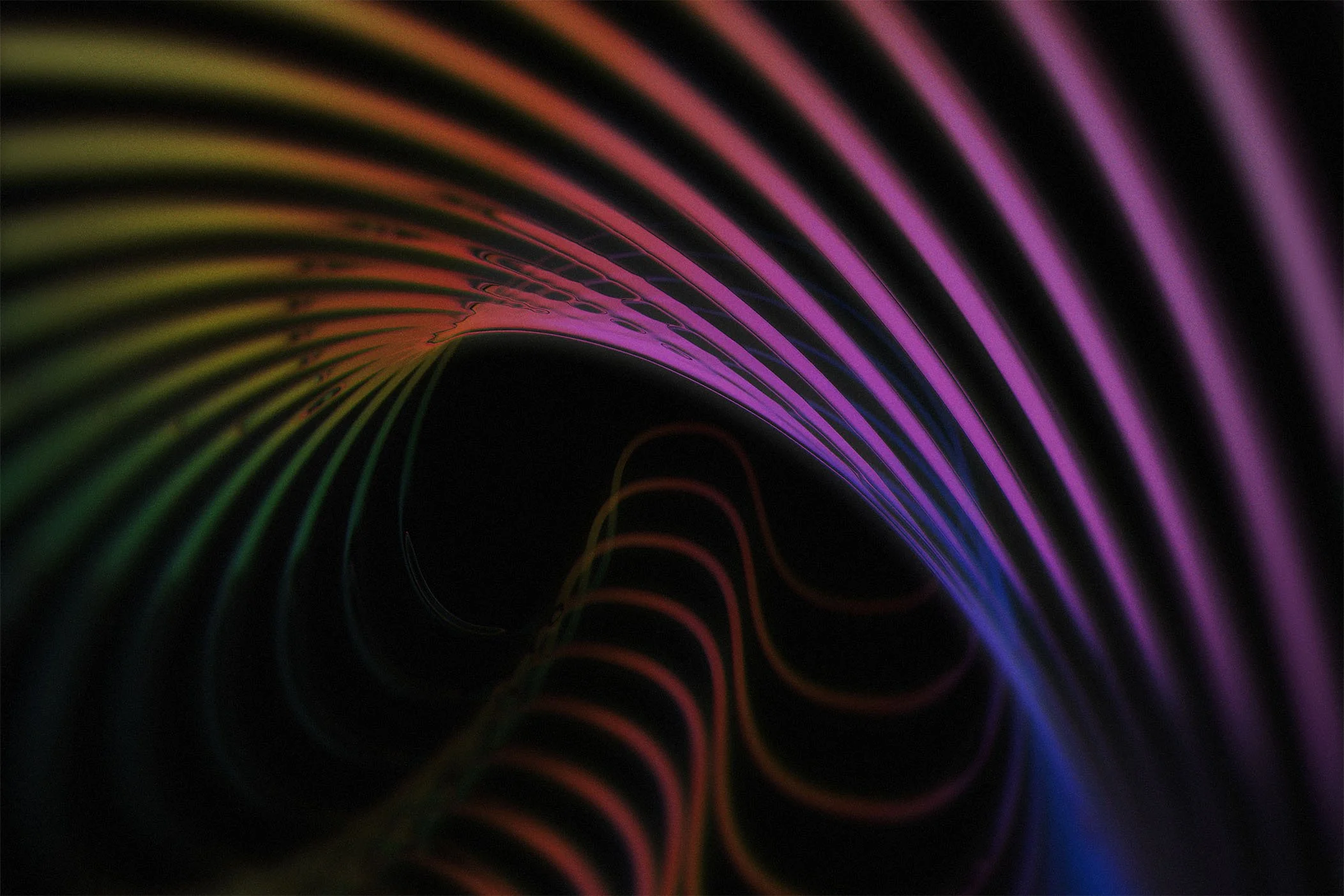 Colorful neon light trails forming a tunnel-like shape with rainbow hues against a dark background.