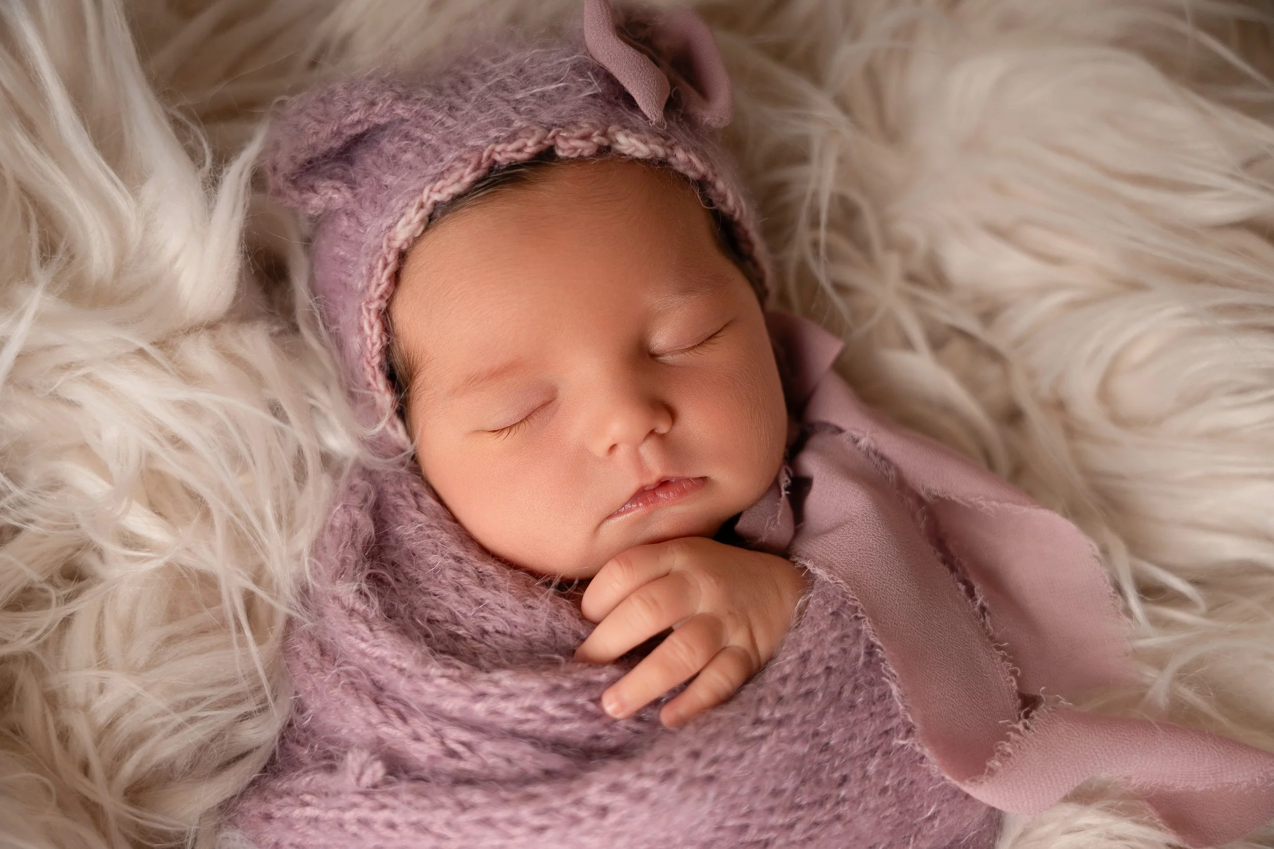 sweet baby photoshoot showing a wrapped newborn baby in photography studio in Canton, GA