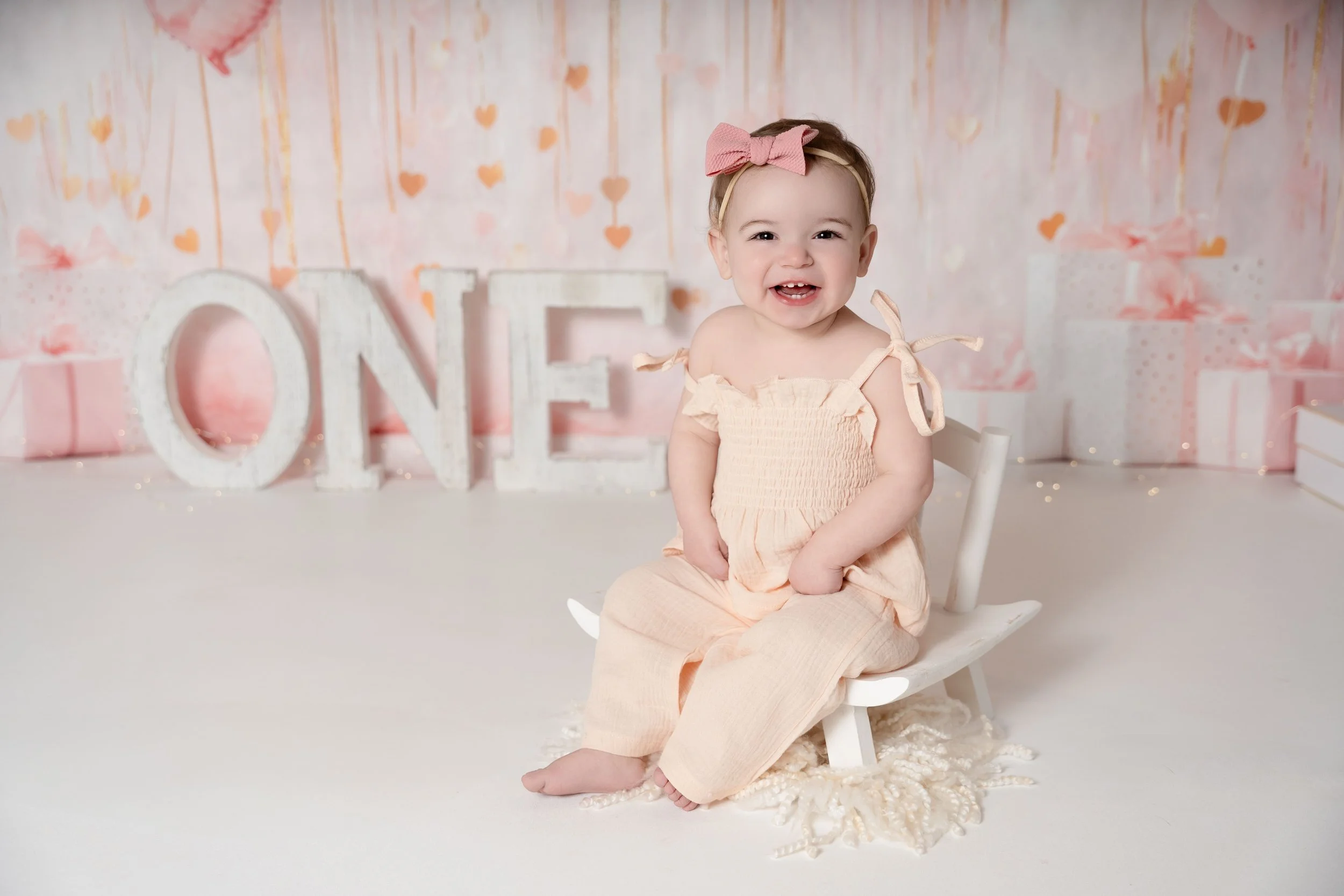sweet baby girl celebrating 1st birthday in photography studio with Captured Moments by Cindy
