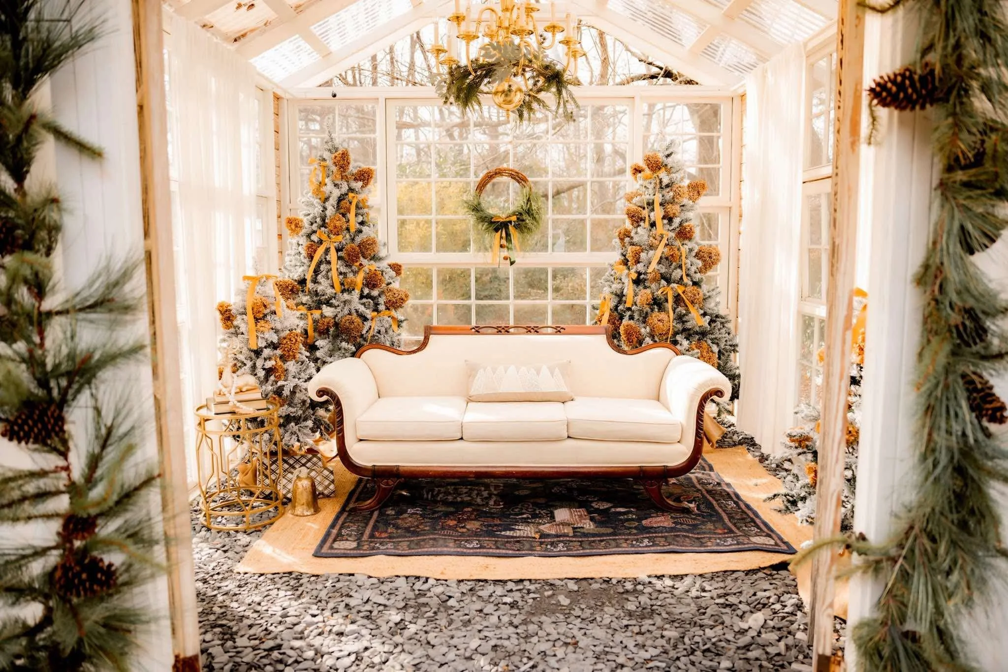image of interior of white greenhouse featuring gold and cream styled Christmas set up for Christmas minis with Santa and Captured Moments by Cindy