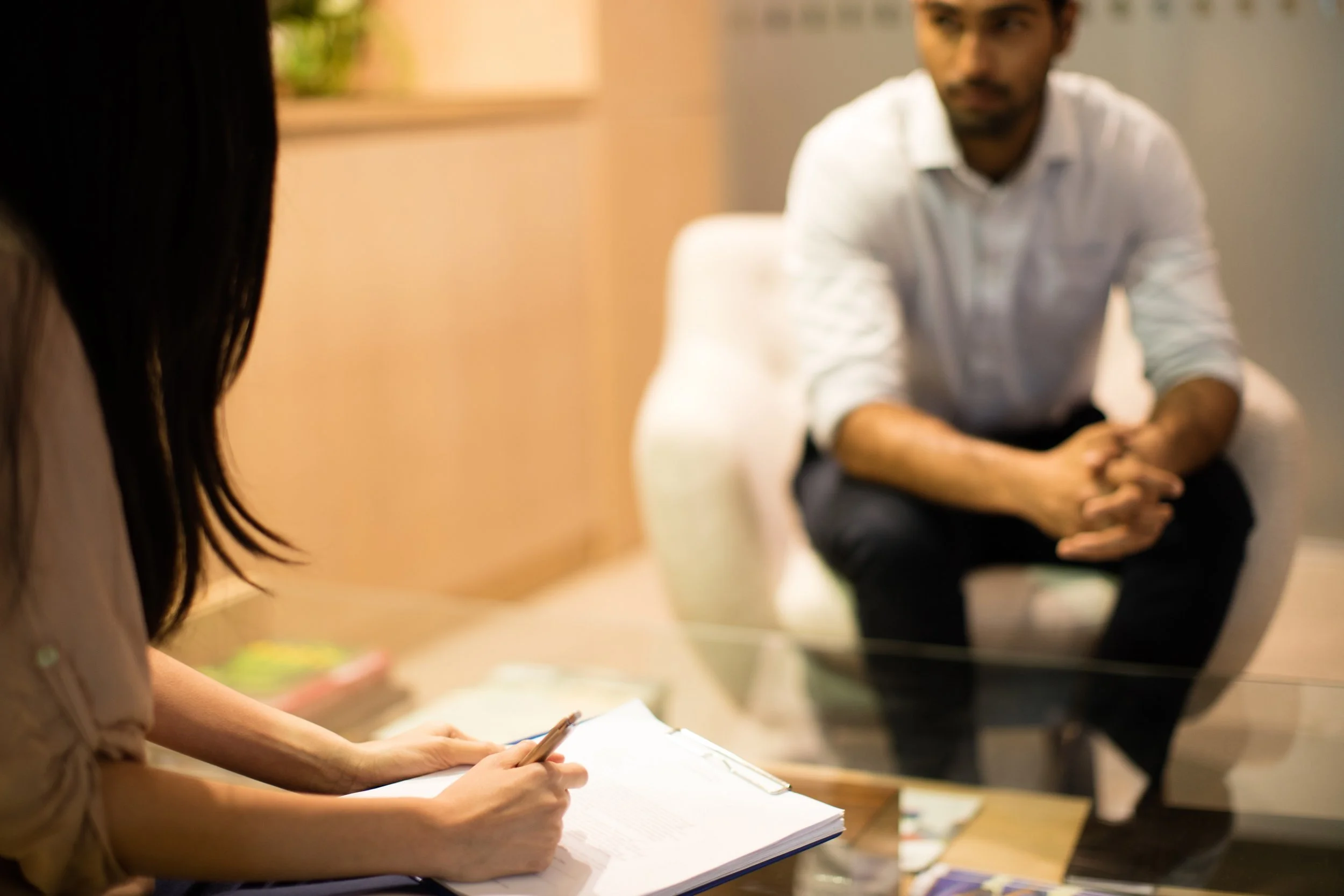 businesswoman-writing-on-clipboard-while-discussin-2025-04-03-02-12-28-utc.jpg
