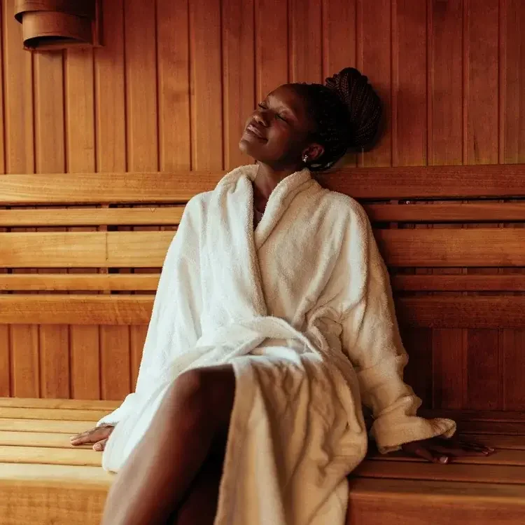 a woman enjoying the infrared sauna before her ashiatsu massage
