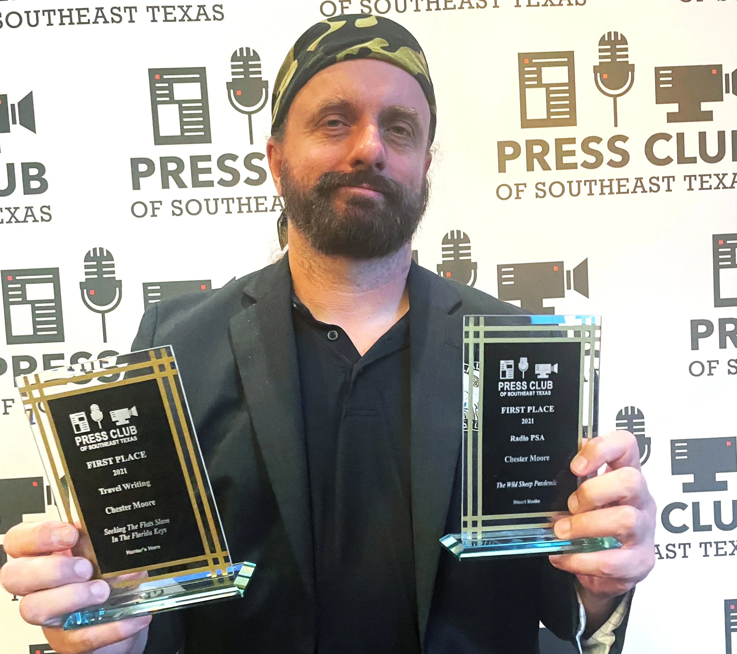 Chester Moore receives Press Club awards for writing, photography, radio and video.