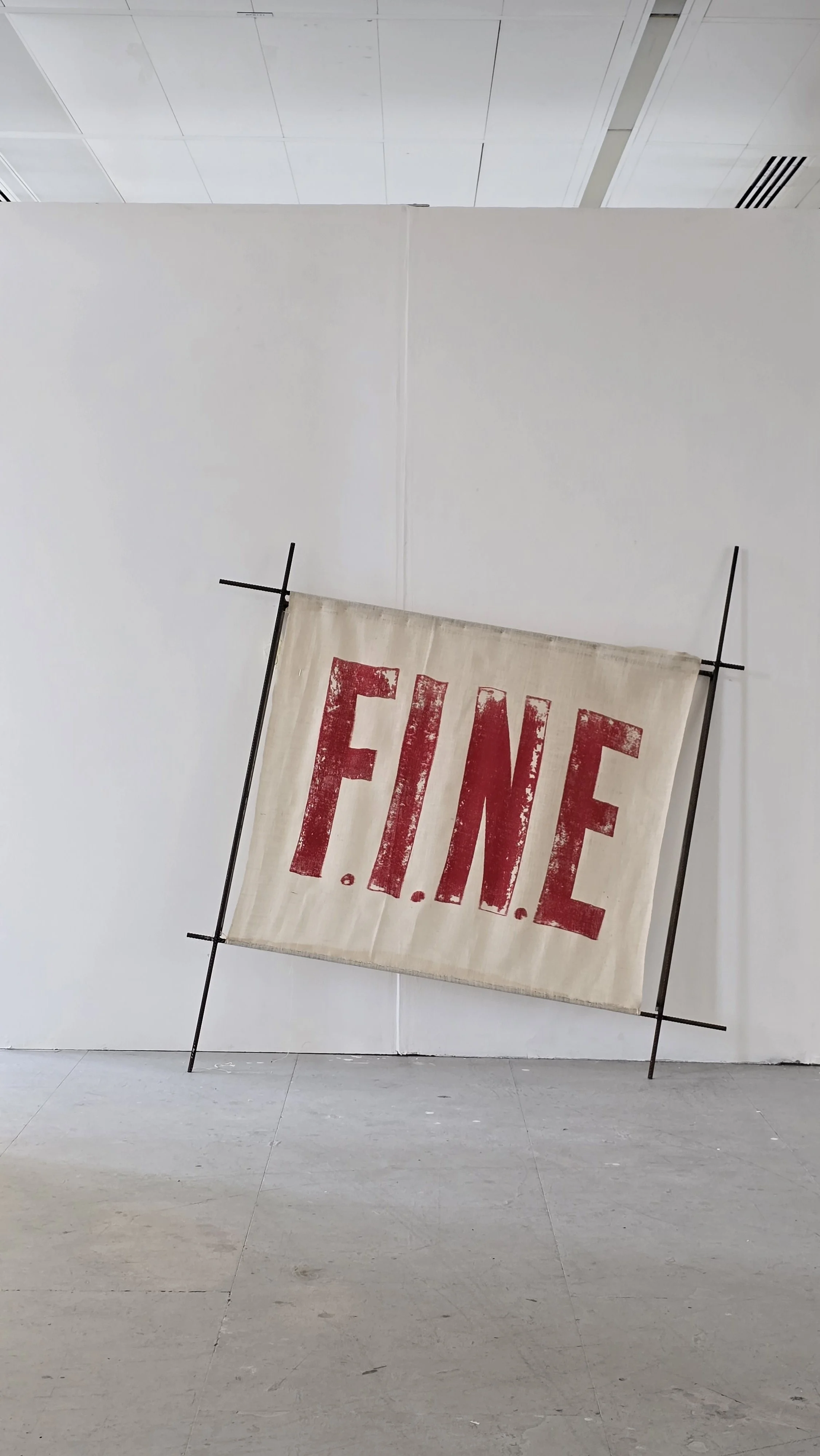 Installation photograph of How Are You Really 2026 by Joanne Tiffany, a Textile Screen Print and metal rebar steel frame against a white wall