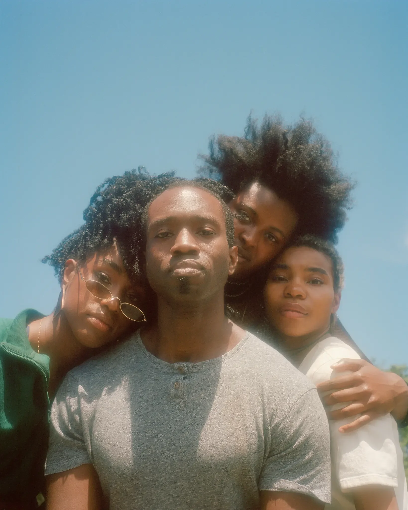 Photo of 4 people leaning in together