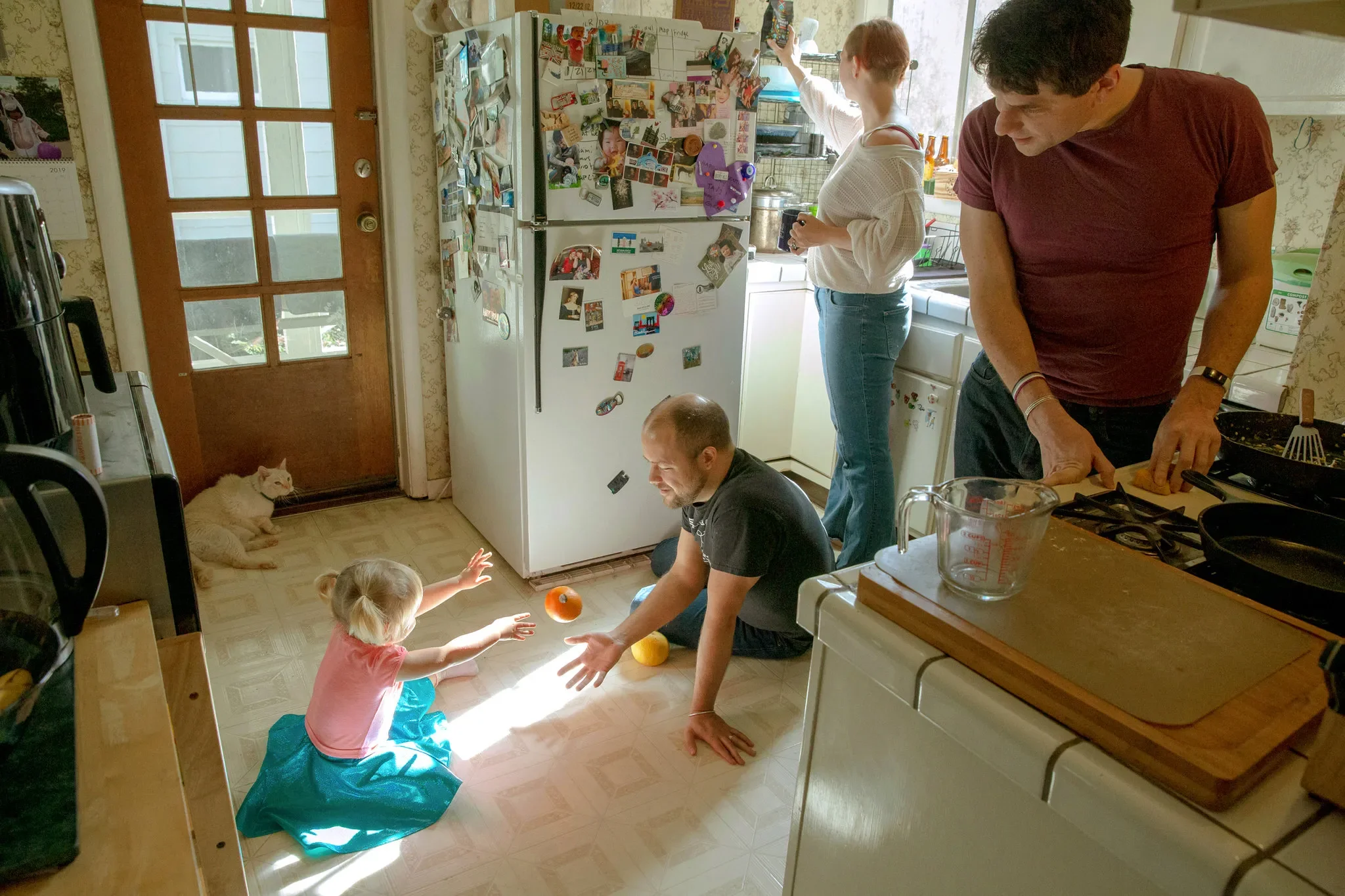Polyamorous family gathered in a kitchen