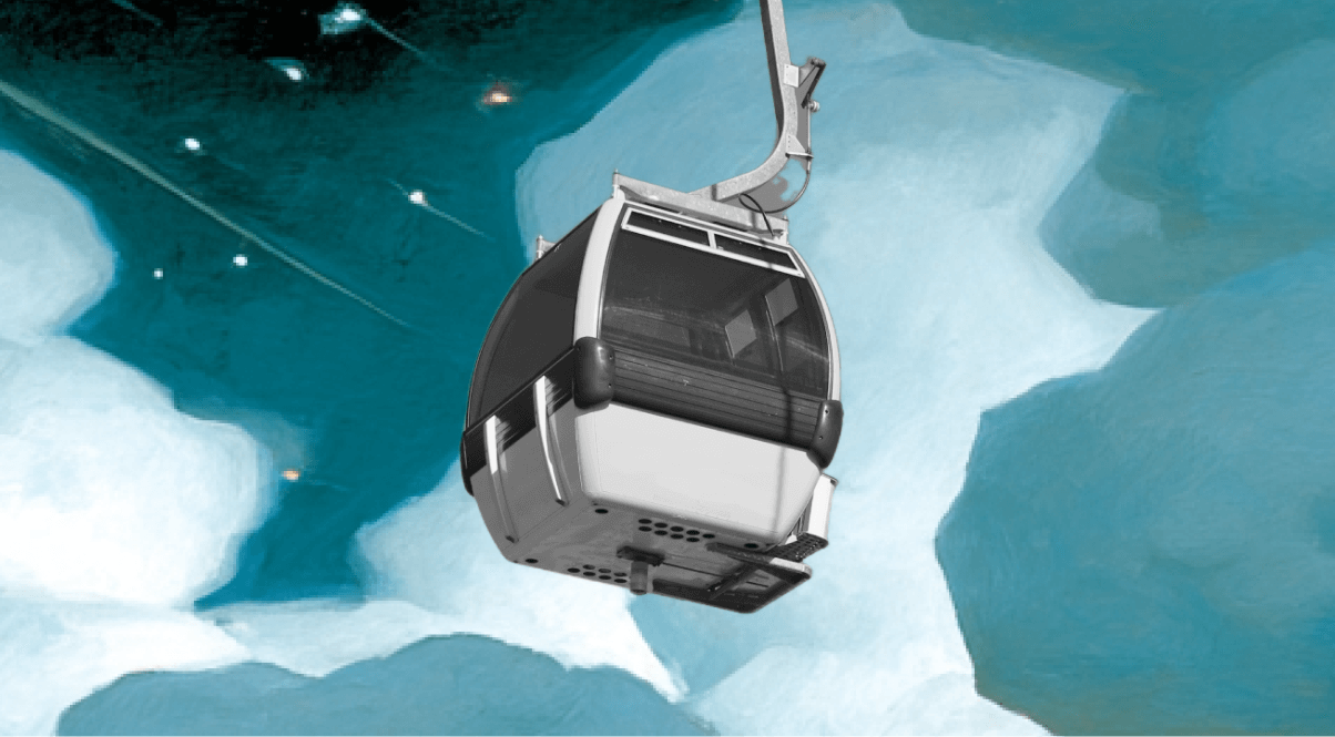Interior of a cable car ascending through snow-covered mountain peaks.