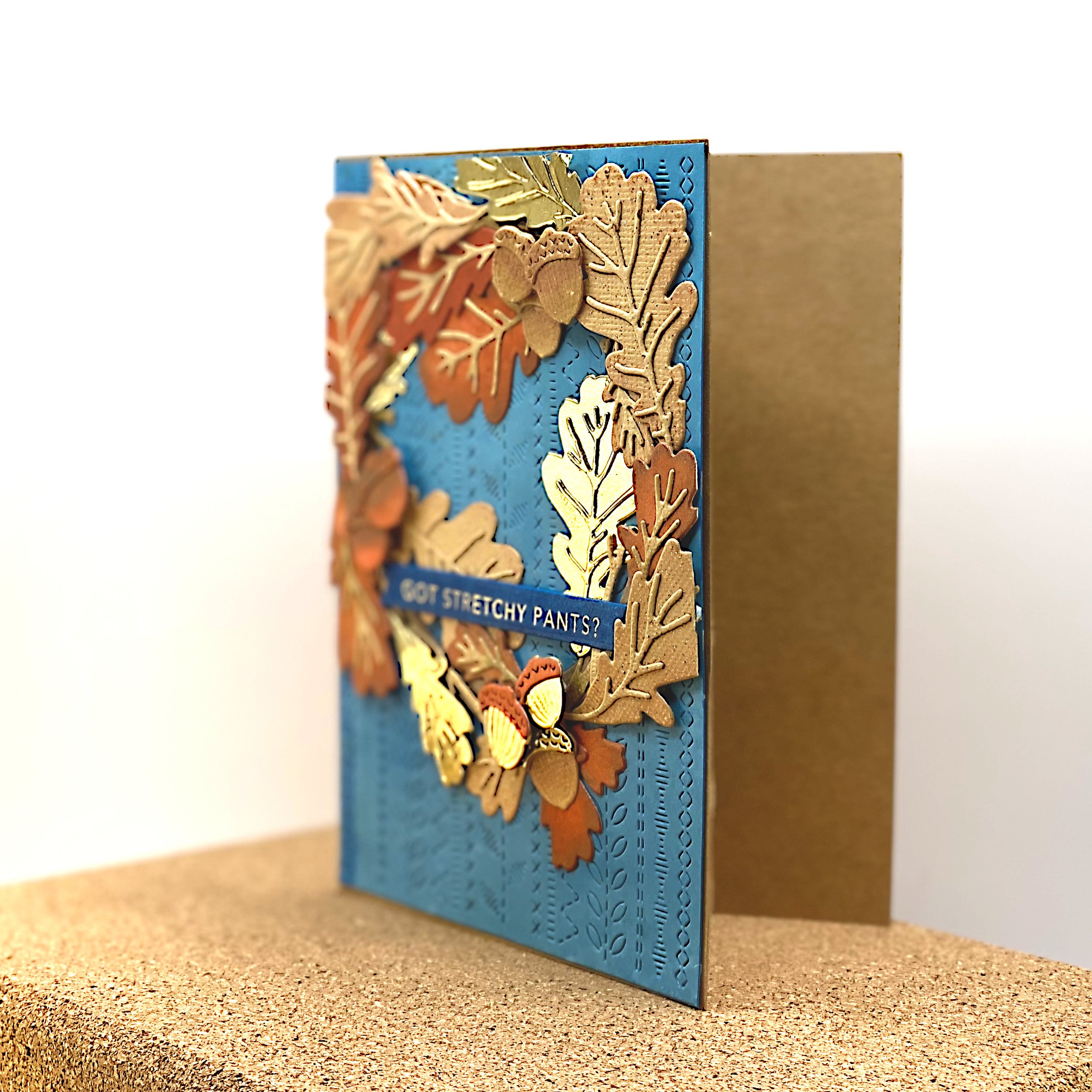 A greeting card with a wreath made out of oak leaves