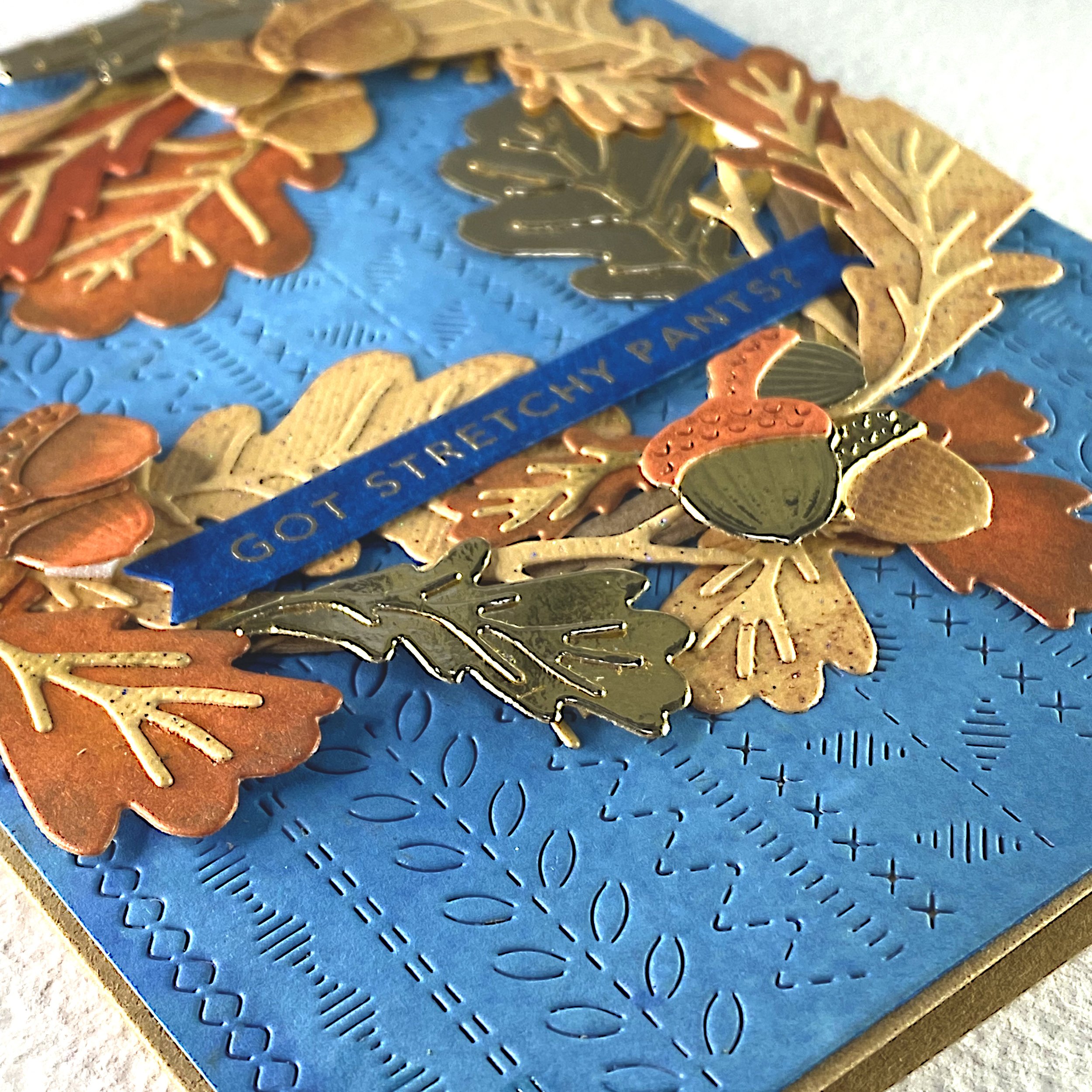 A greeting card with a wreath made out of oak leaves