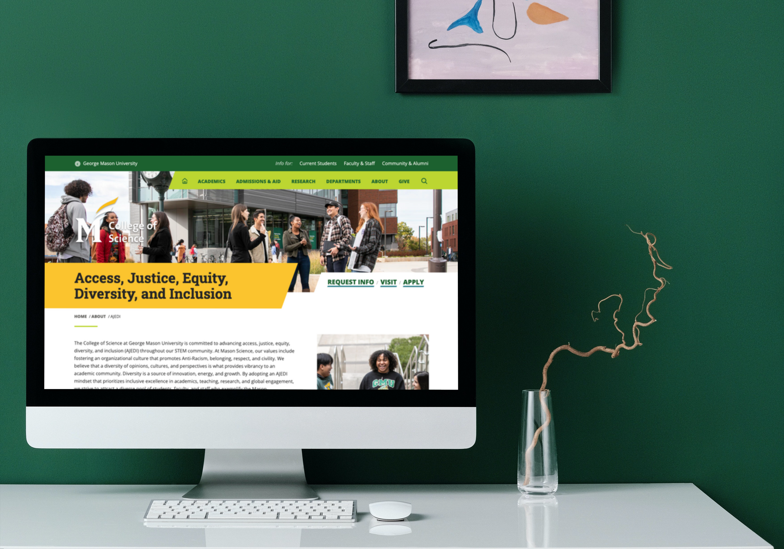 iMac on the white table in front of the dark green wall_Mason_Diversitypage.png