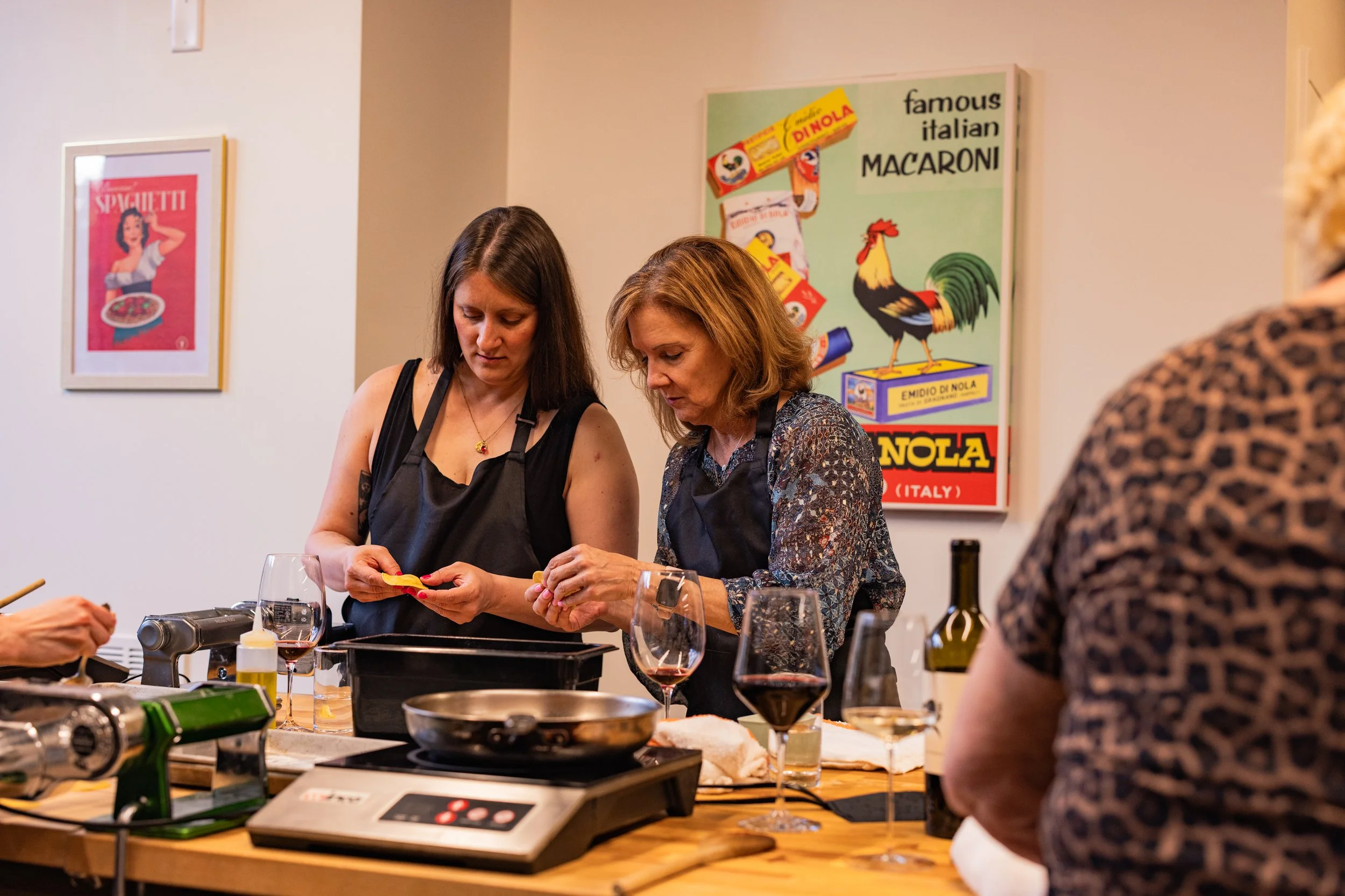 two women cooking pasta