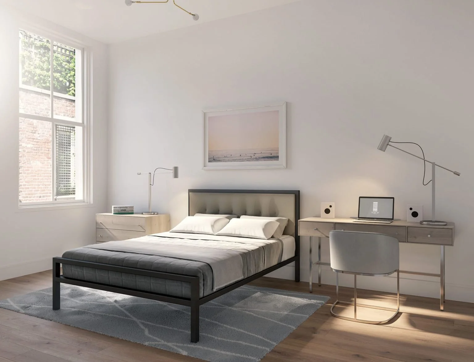 Minimalist bedroom with a large window, a bed with black frame and gray bedding, a nightstand with a lamp, and a desk with a chair, laptop, and speakers, illuminated by daylight.