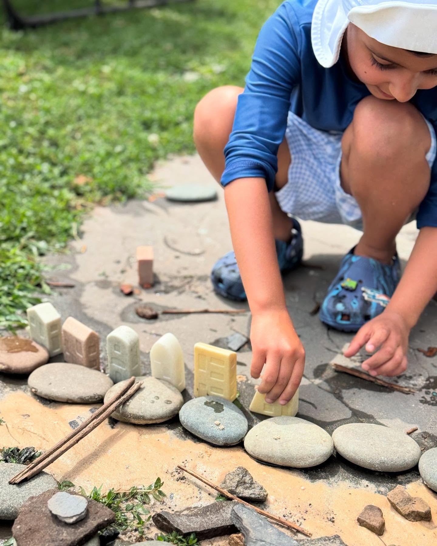 This week our new water table quickly became a hub of serious engineering.

Campers began by building a city from rocks, sand, leaves, and a few stone toys. An ocean was needed next&mdash;but a quick pour from the mud-kitchen buckets only left a pudd