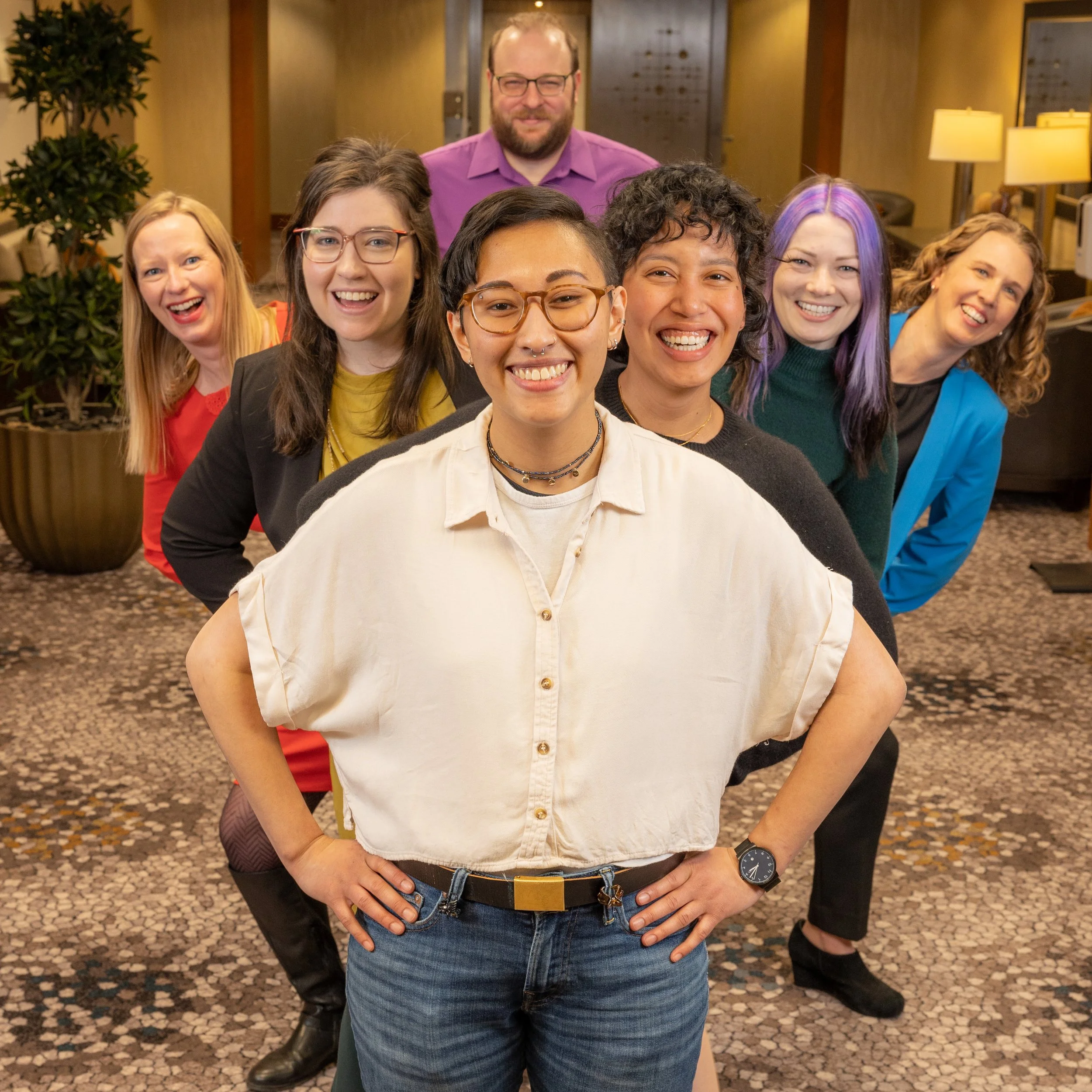 Our team posing fanned out behind each other, grinning.