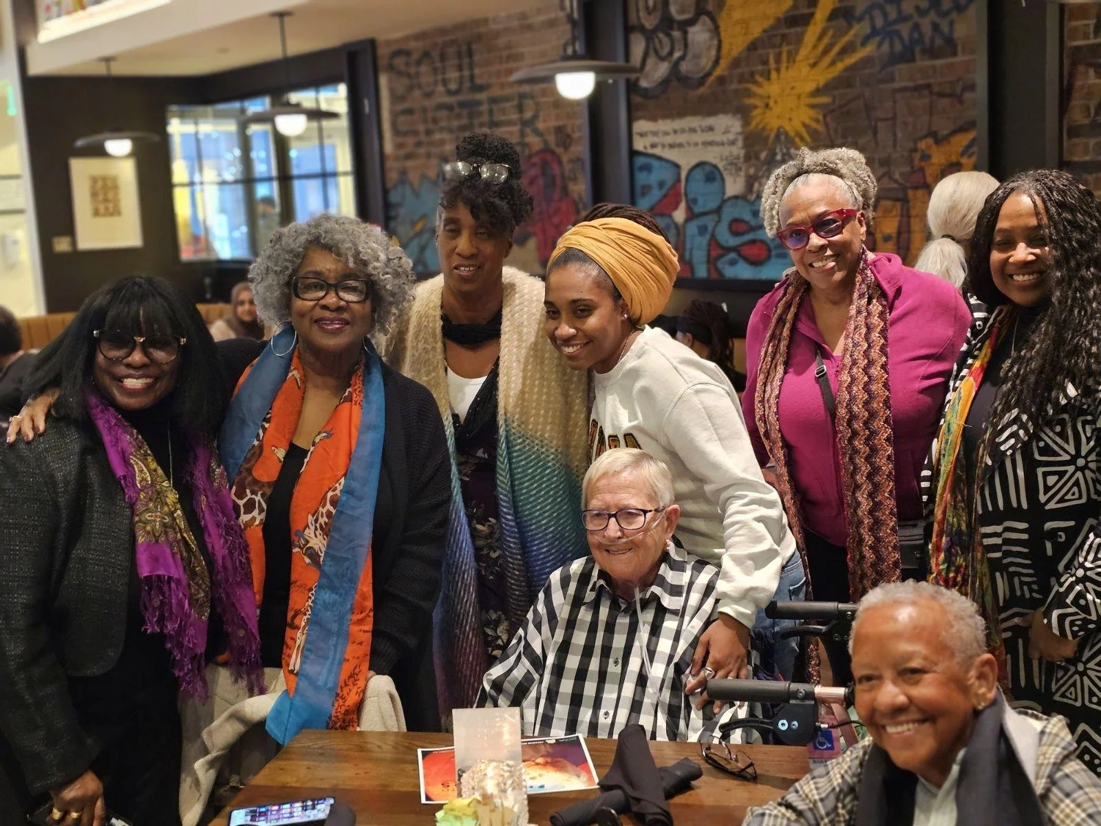 Carla DuPree, Joanne Gabbin, Jessea Gabbin, Liseli Fitzpatrick, Maryemma Graham, Alysia Dempsey, Ginney Fowler, and Nikki Giovanni attend the screening of the documentary “Going to Mars: The Nikki Giovanni Project” at Busboys and Poets in Washingto