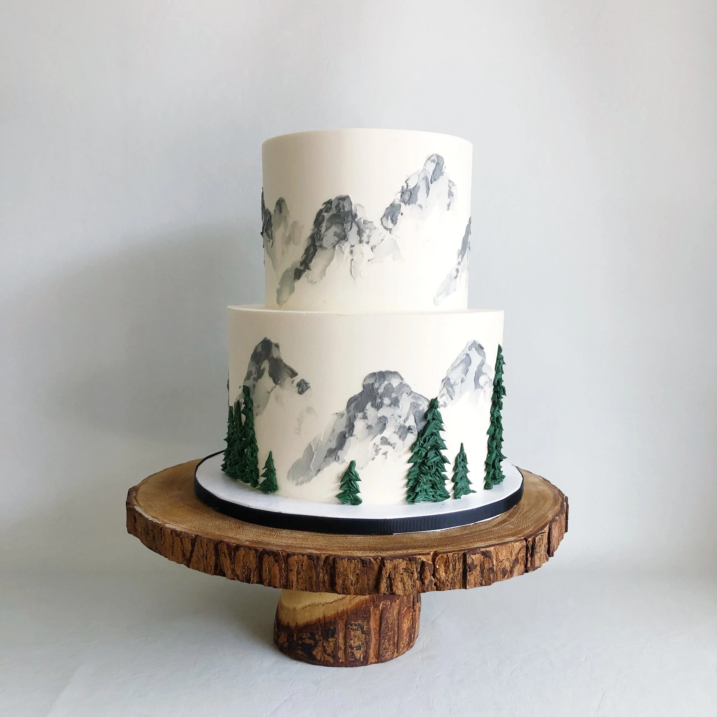 Coloured buttercream mountains + trees design