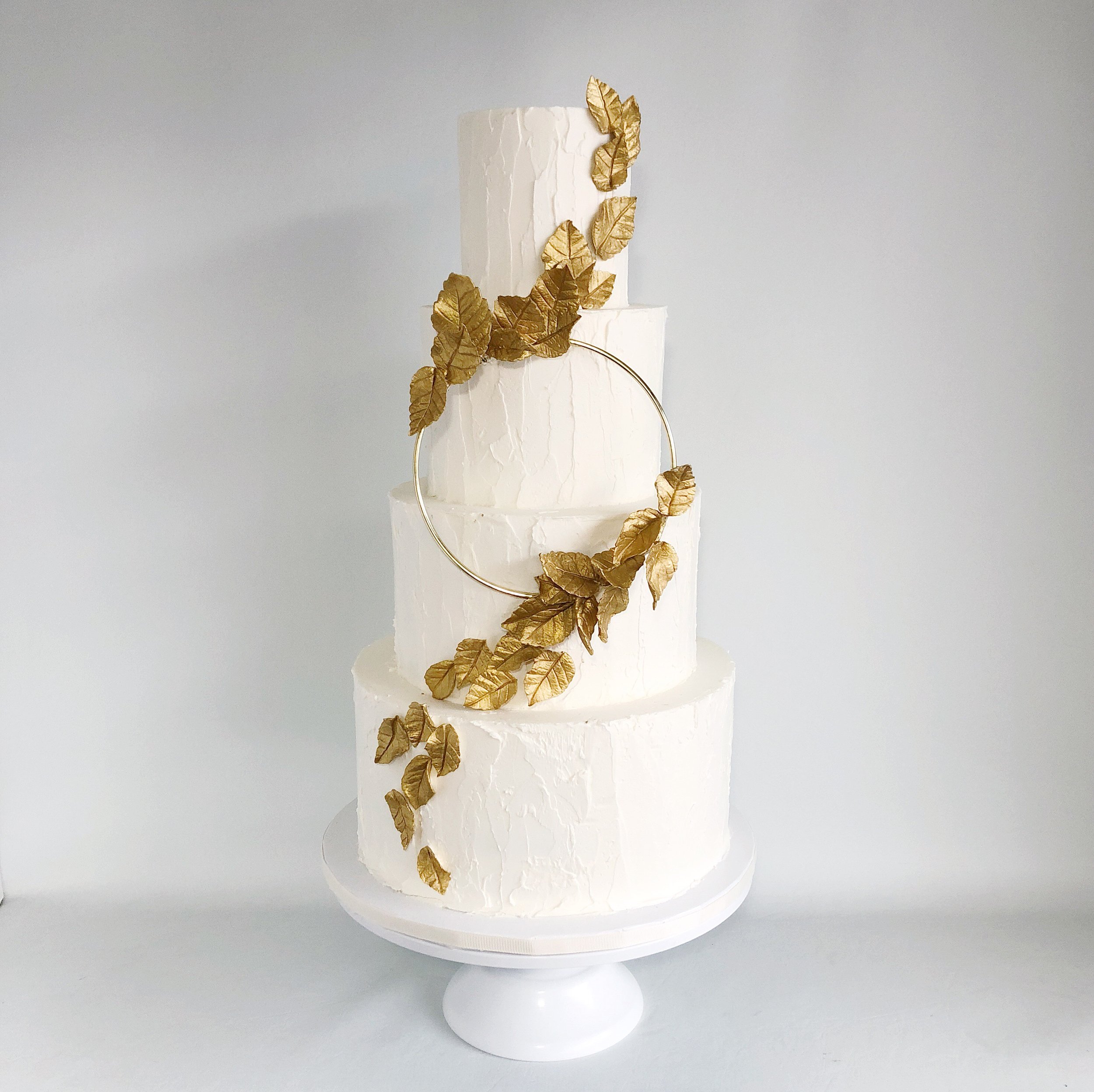 Soft textured buttercream with gold sugar flowers