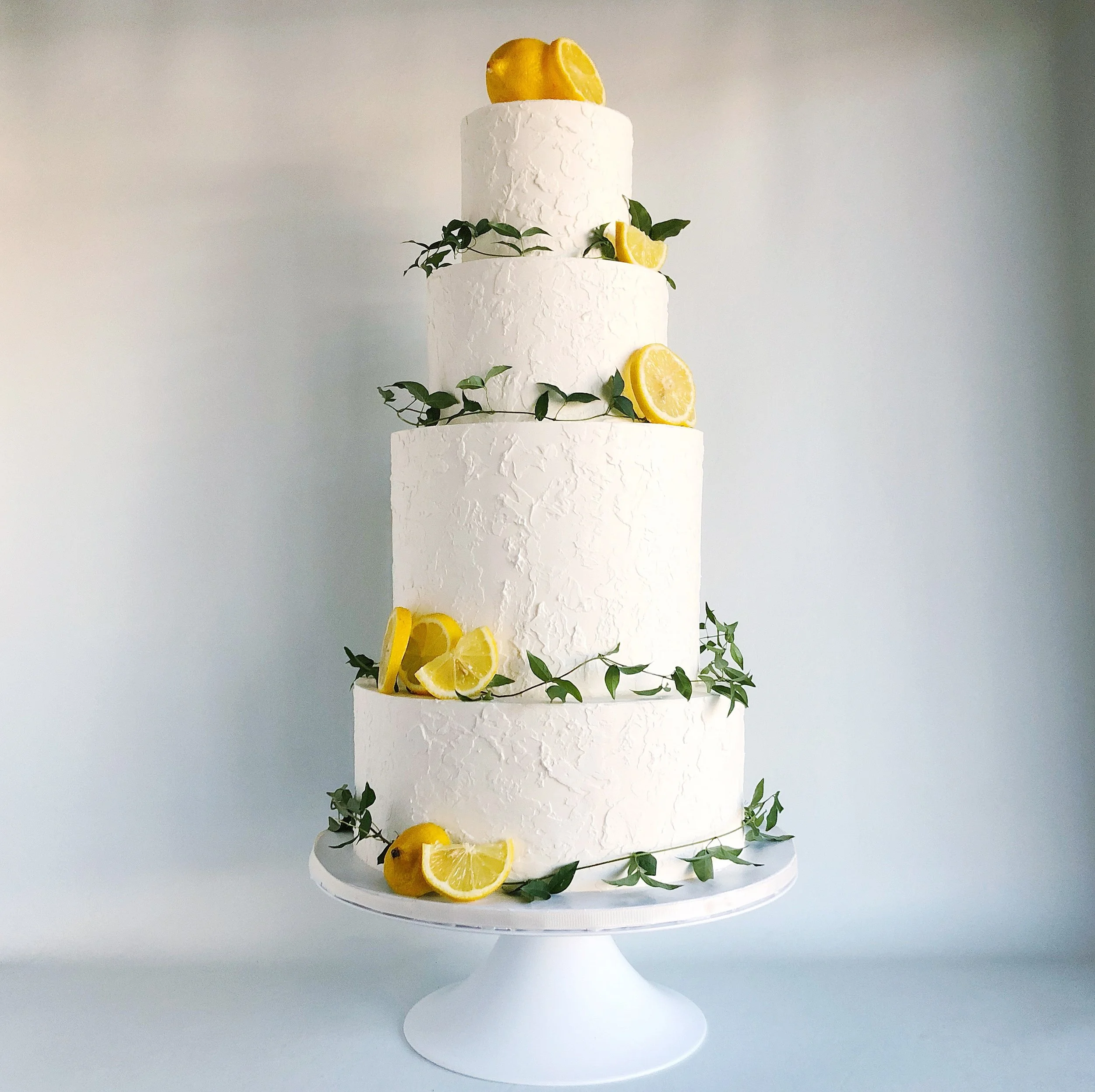 Soft textured buttercream with fresh greenery and lemons